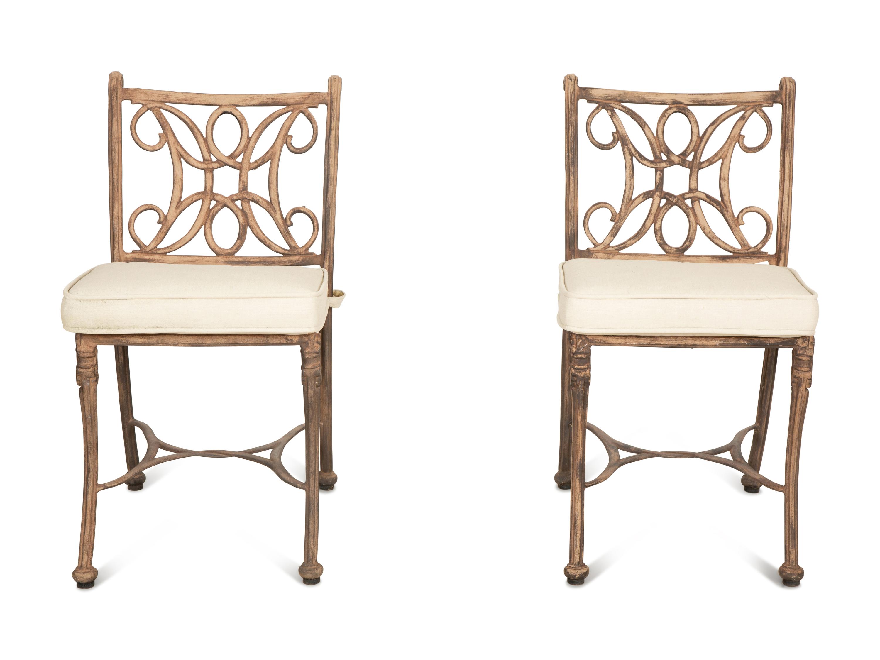 A Pair of Patinated Metal Garden Chairs and Side Table