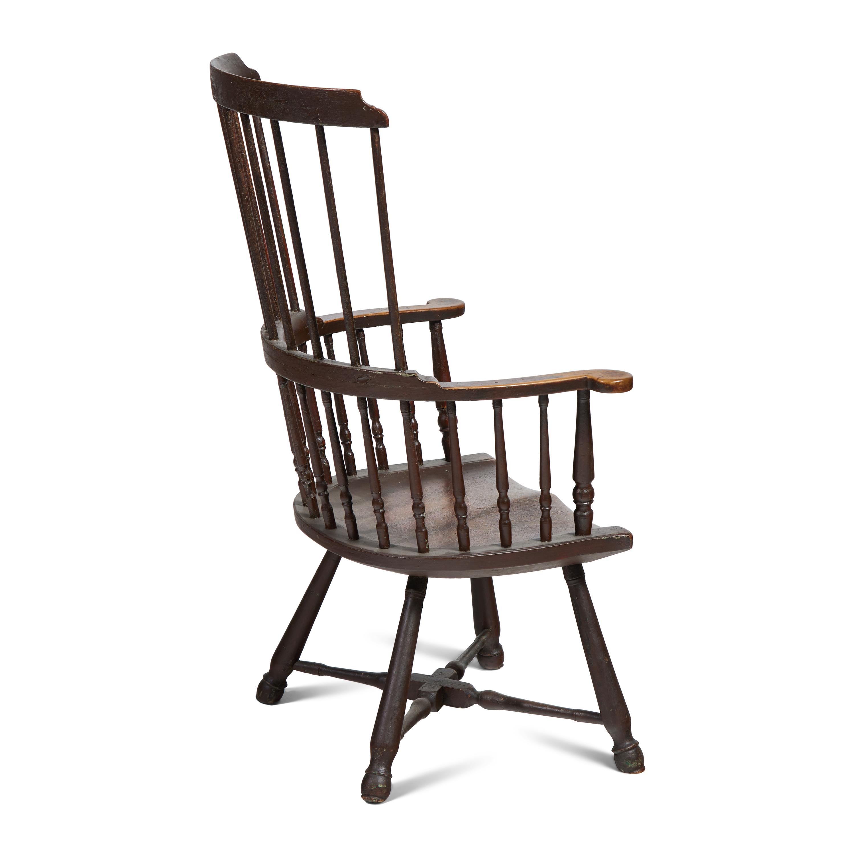 A Turned and Black-Painted Comb-Back Windsor Armchair