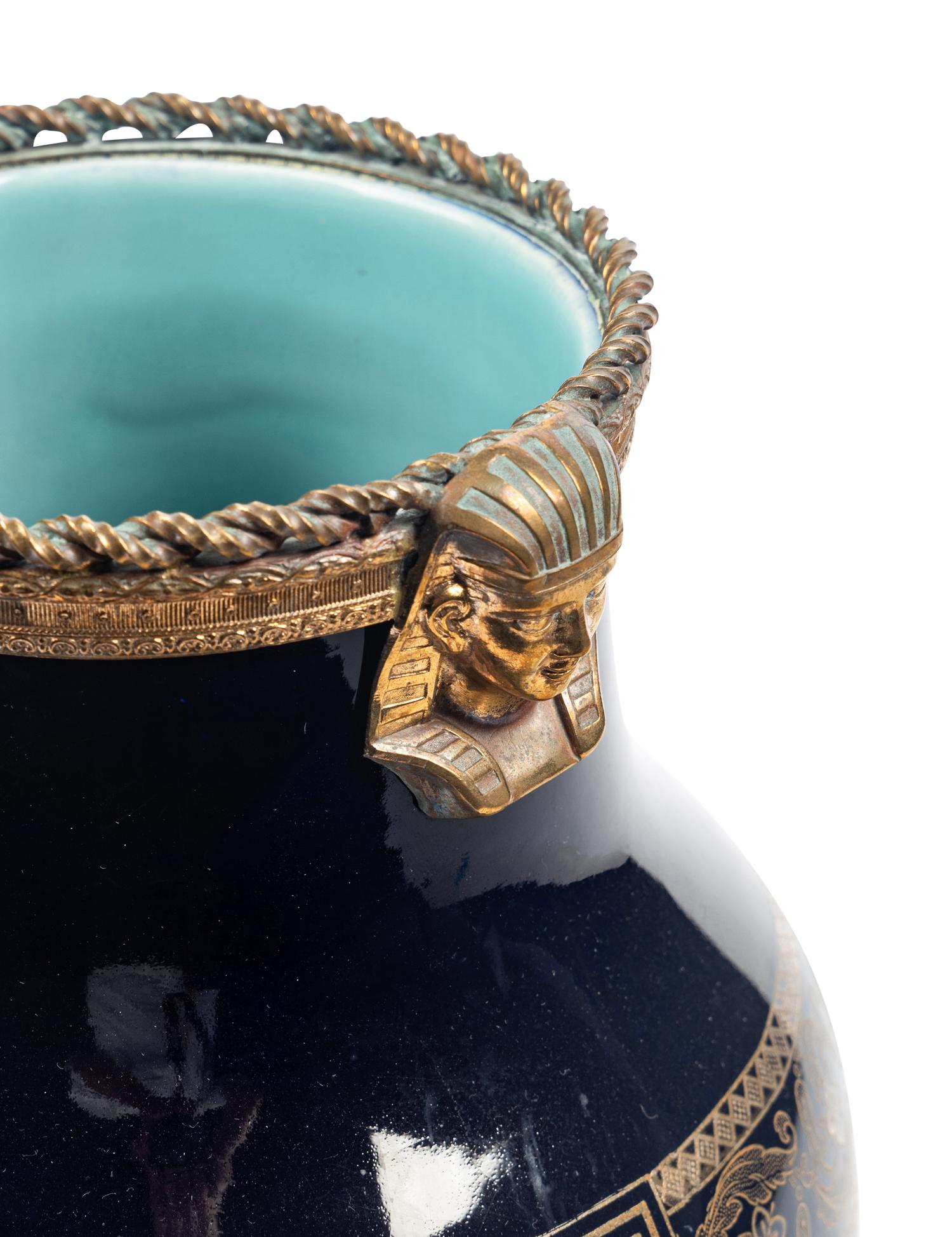 A Sarreguemines Cobalt Glazed Three-Piece Garniture with Egyptian Motif Mounts