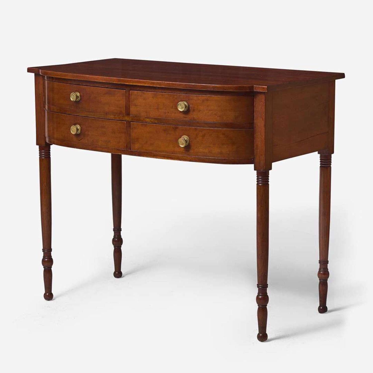 A Federal bowfront cherry sideboard or serving table, circa 1810