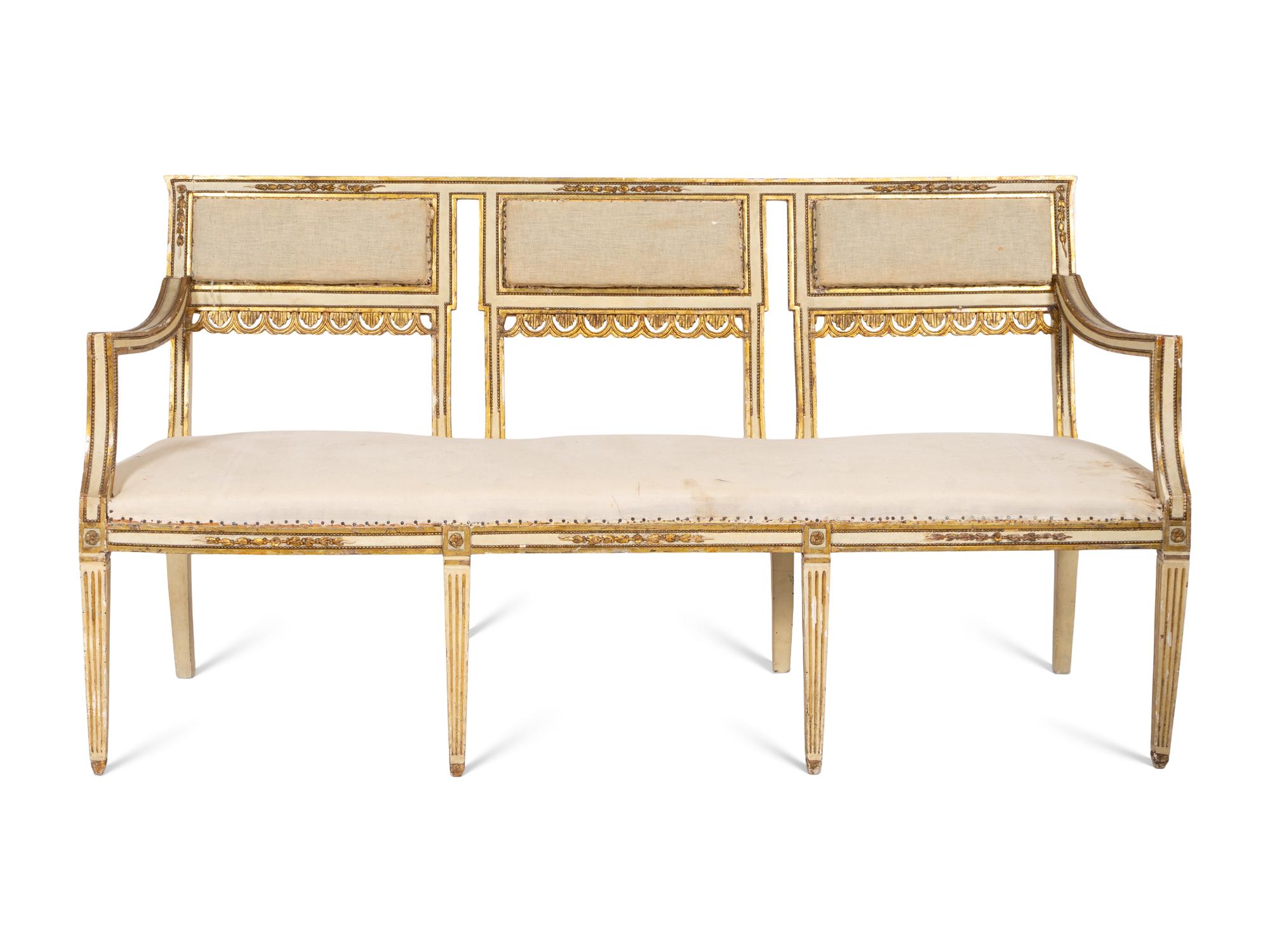 An Italian Louis XVI Style Cream Painted and Parcel Gilt Parlor Suite