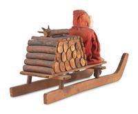 A Papier-Mâché Santa Claus on Log Sleigh