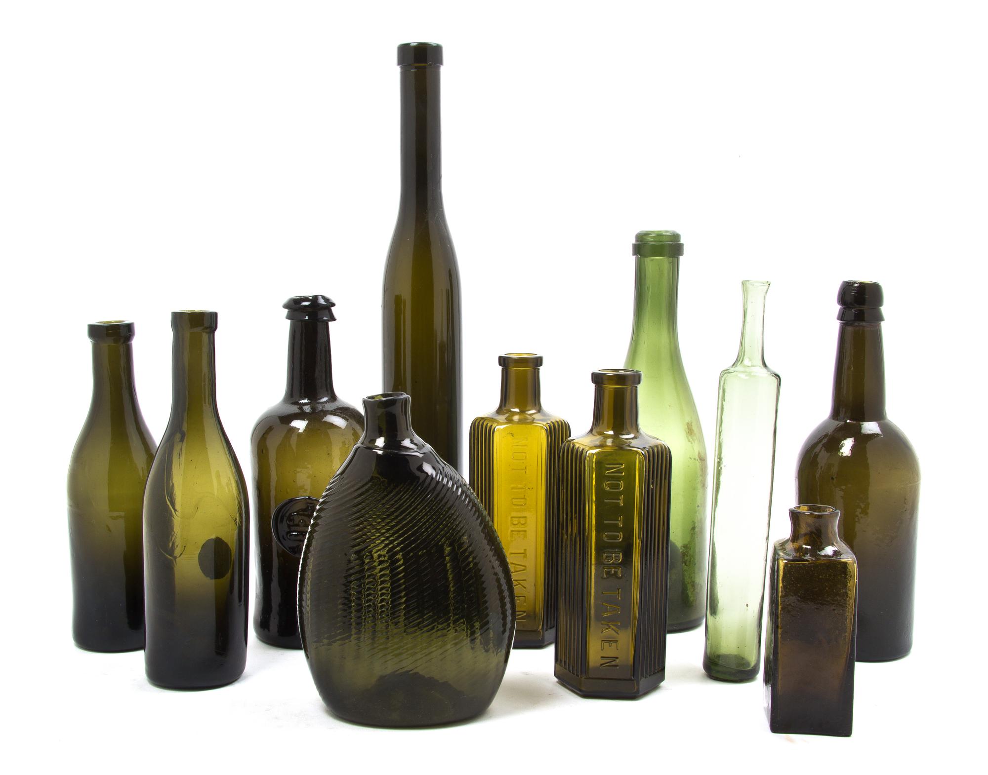 A Collection of Early American Olive Glass Bottles, Height of tallest 14 5/8 inches.