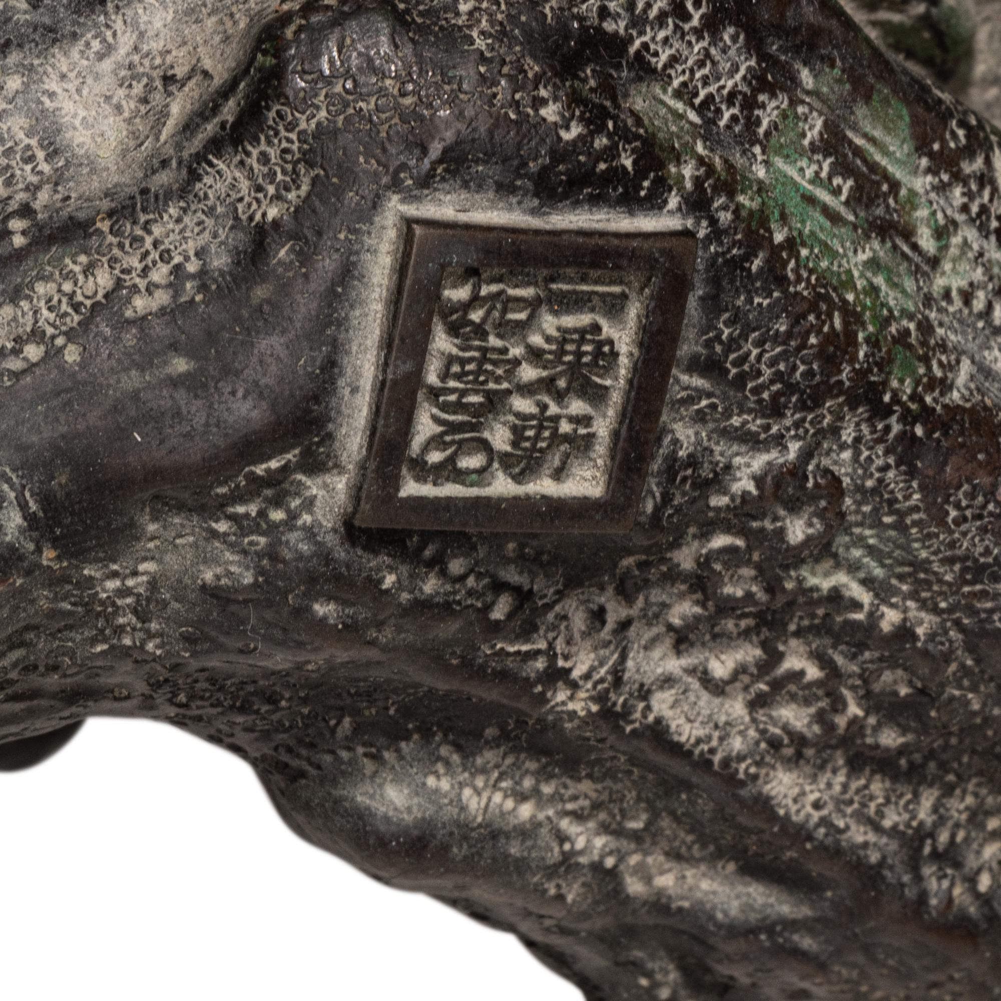 A Japanese Bronze Figural Group of a Hawk Hunting Monkeys