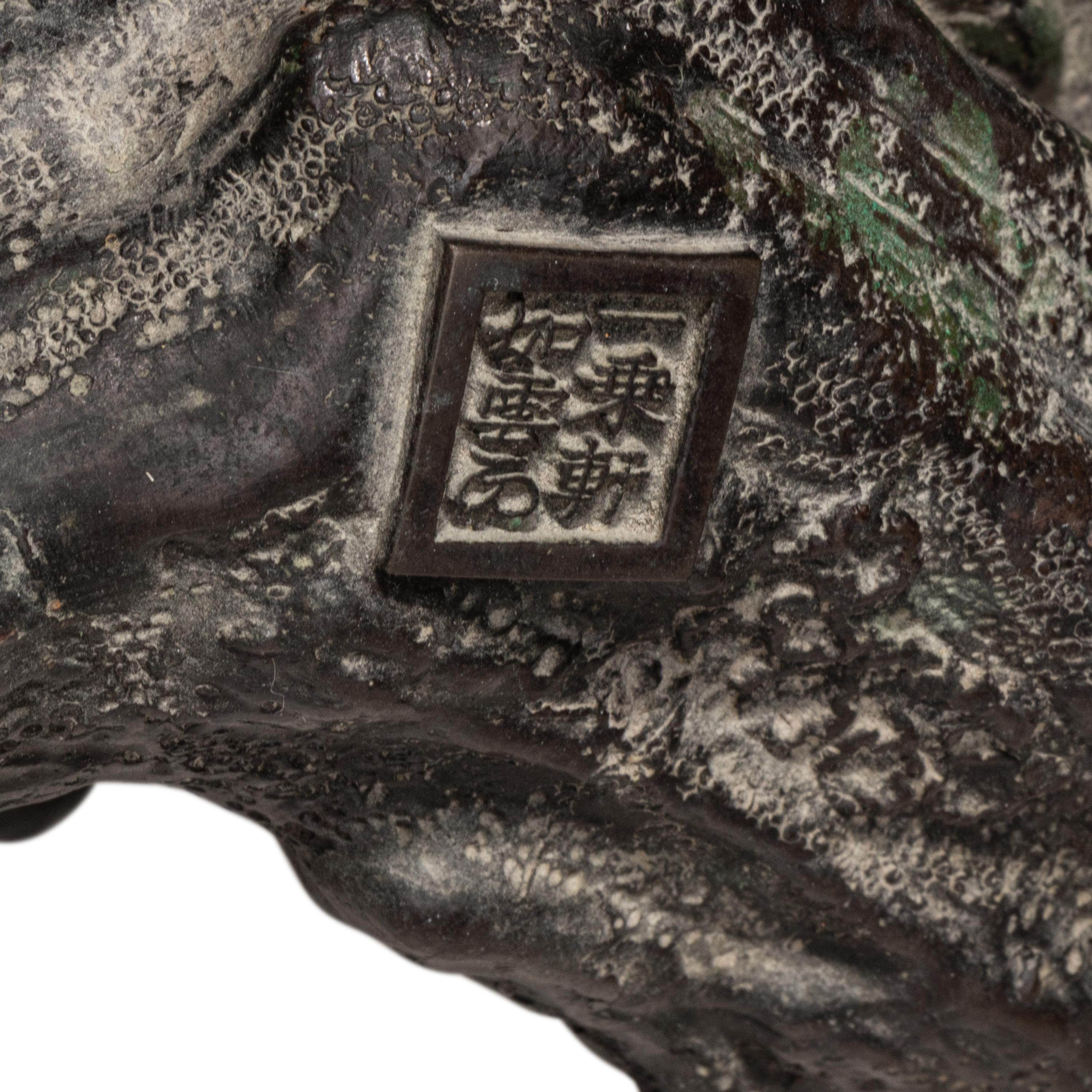 A Japanese Bronze Figural Group of a Hawk Hunting Monkeys