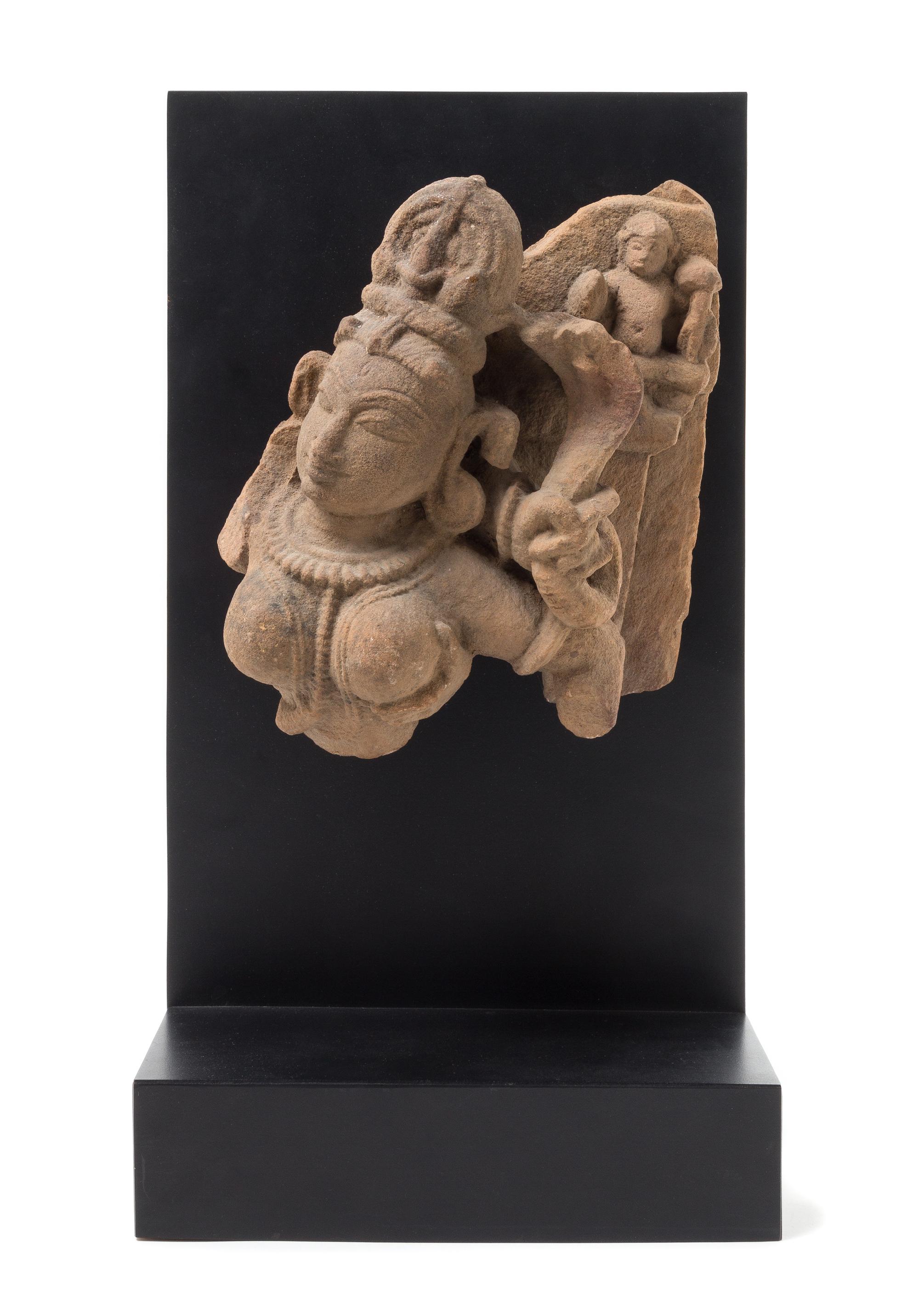 An Indian Red Sandstone Fragment of Shiva and Parvati Height 9 1/2 inches. — 11TH CENTURY