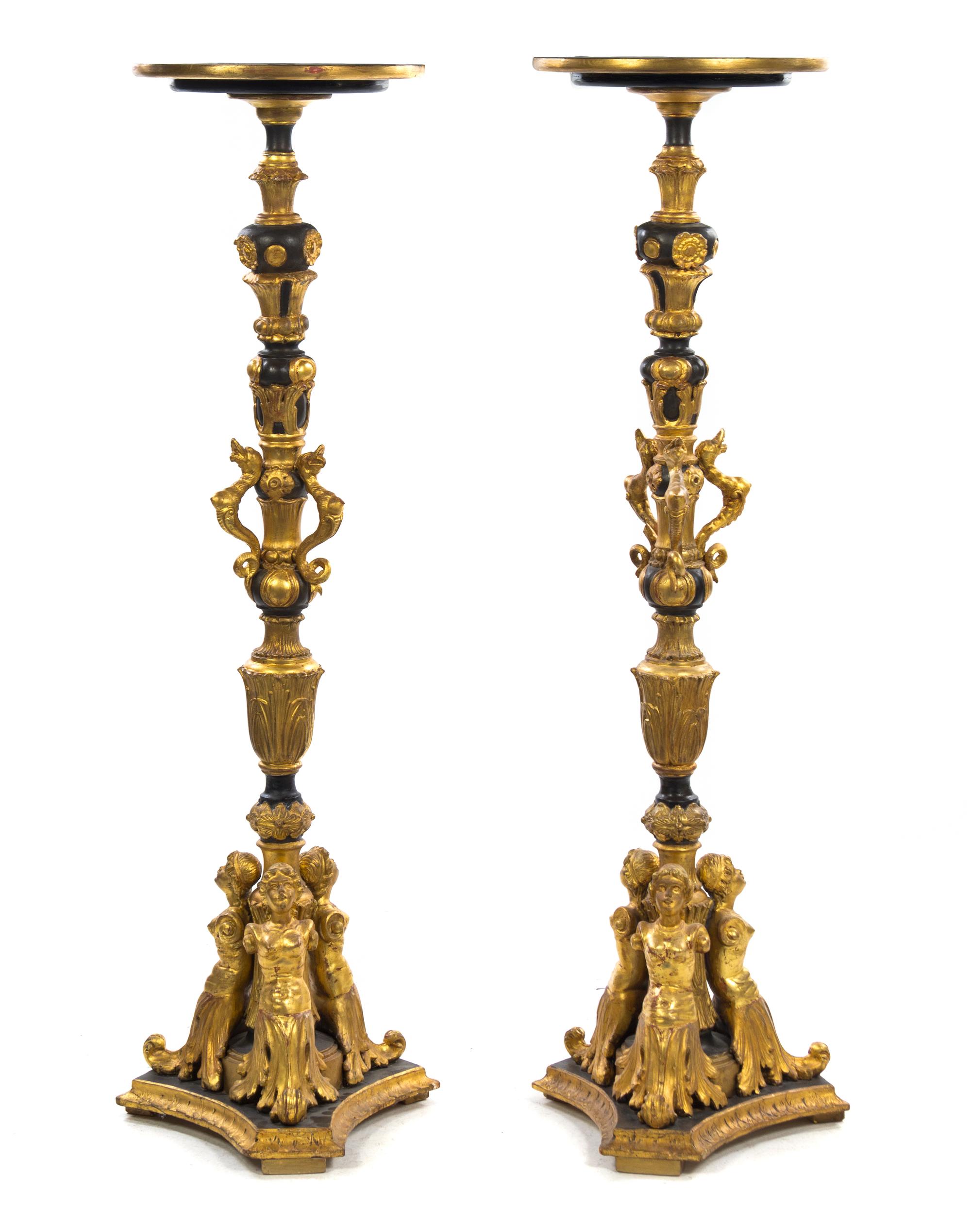 A Pair of Italian Ebonized and Giltwood Columns, Height 58 1/2 inches.