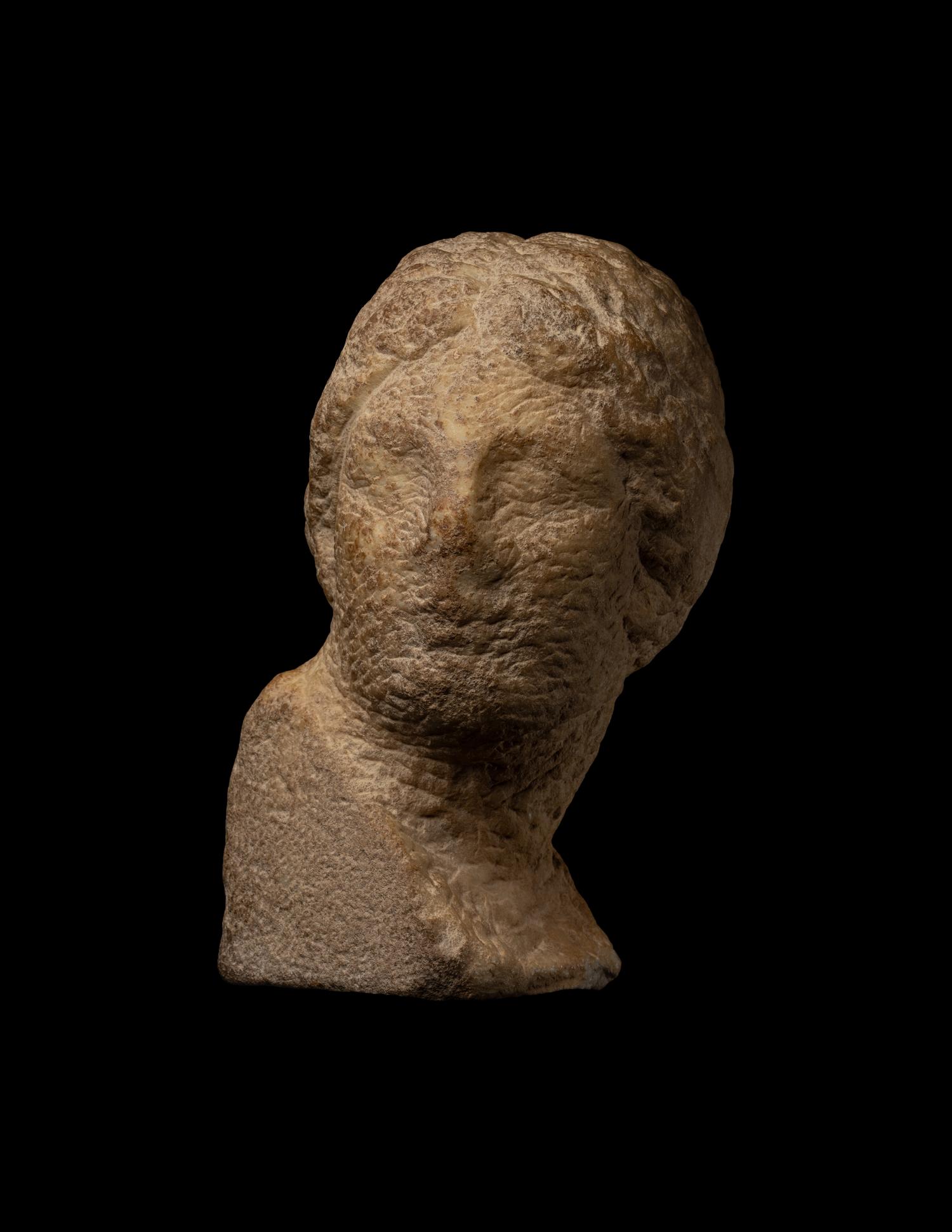 An Unfinished Greek Marble Head of a Woman