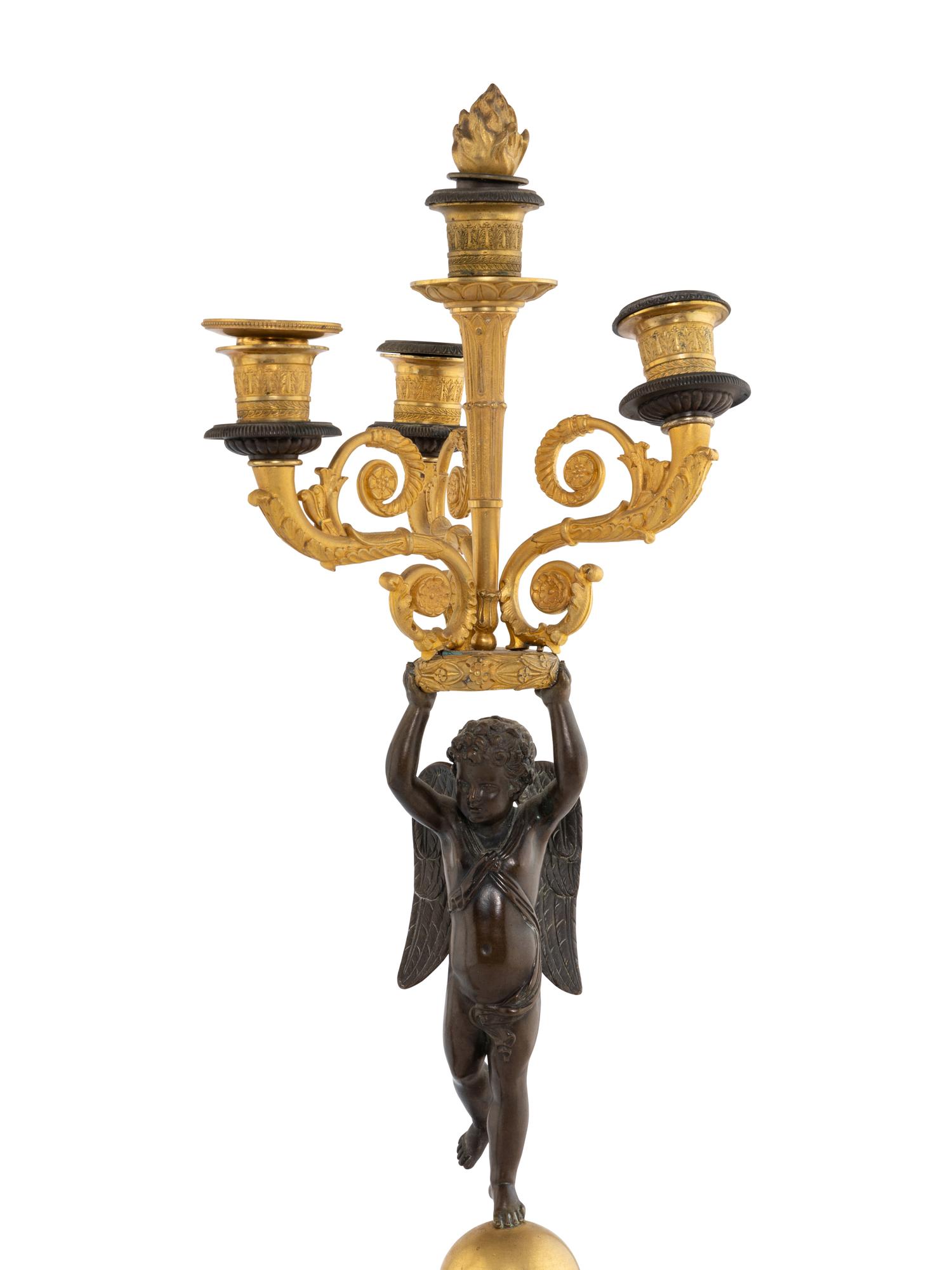 A Pair of Empire Style Gilt and Patinated Bronze Figural Candelabra