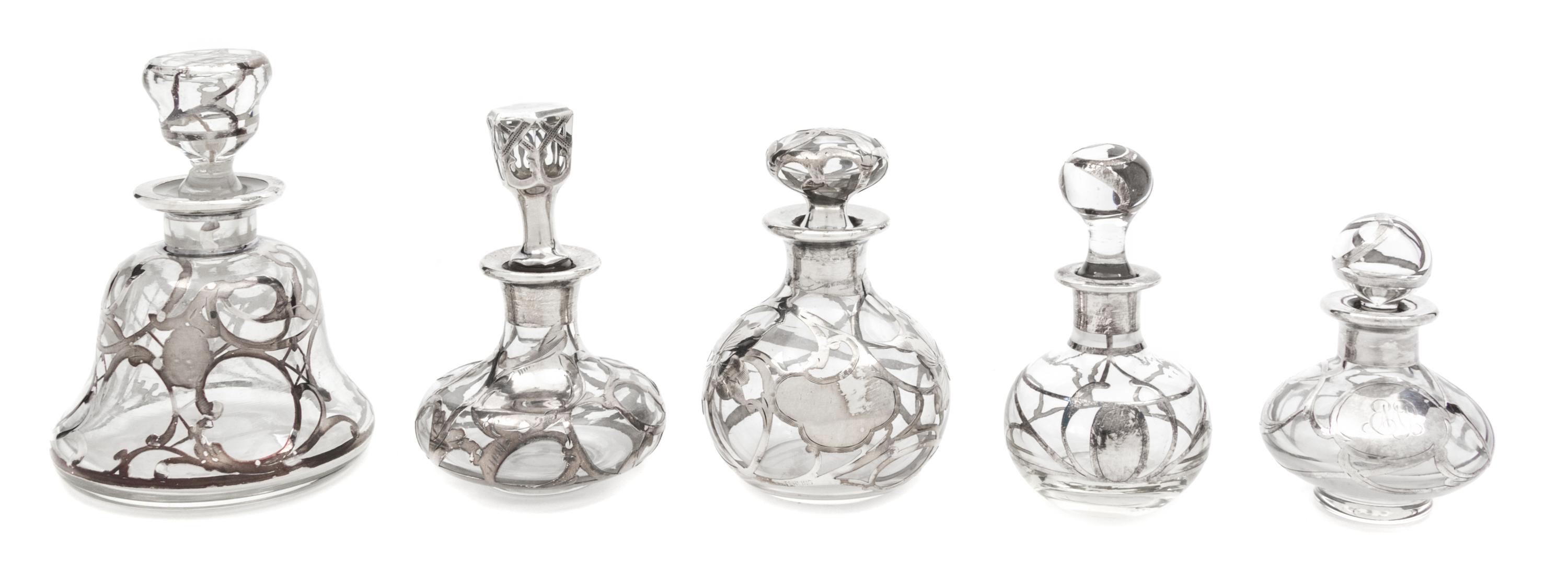 A Group of Five Silver Overlay Glass Perfume Bottles Height of tallest 4 3/4 inches.