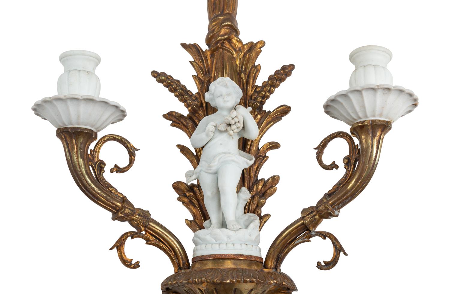 A Pair of Continental Gilt Bronze and Bisque Porcelain Two-Light Sconces
