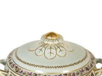 A Mottahedeh Porcelain Tureen, Underplate, and Spoon Rest