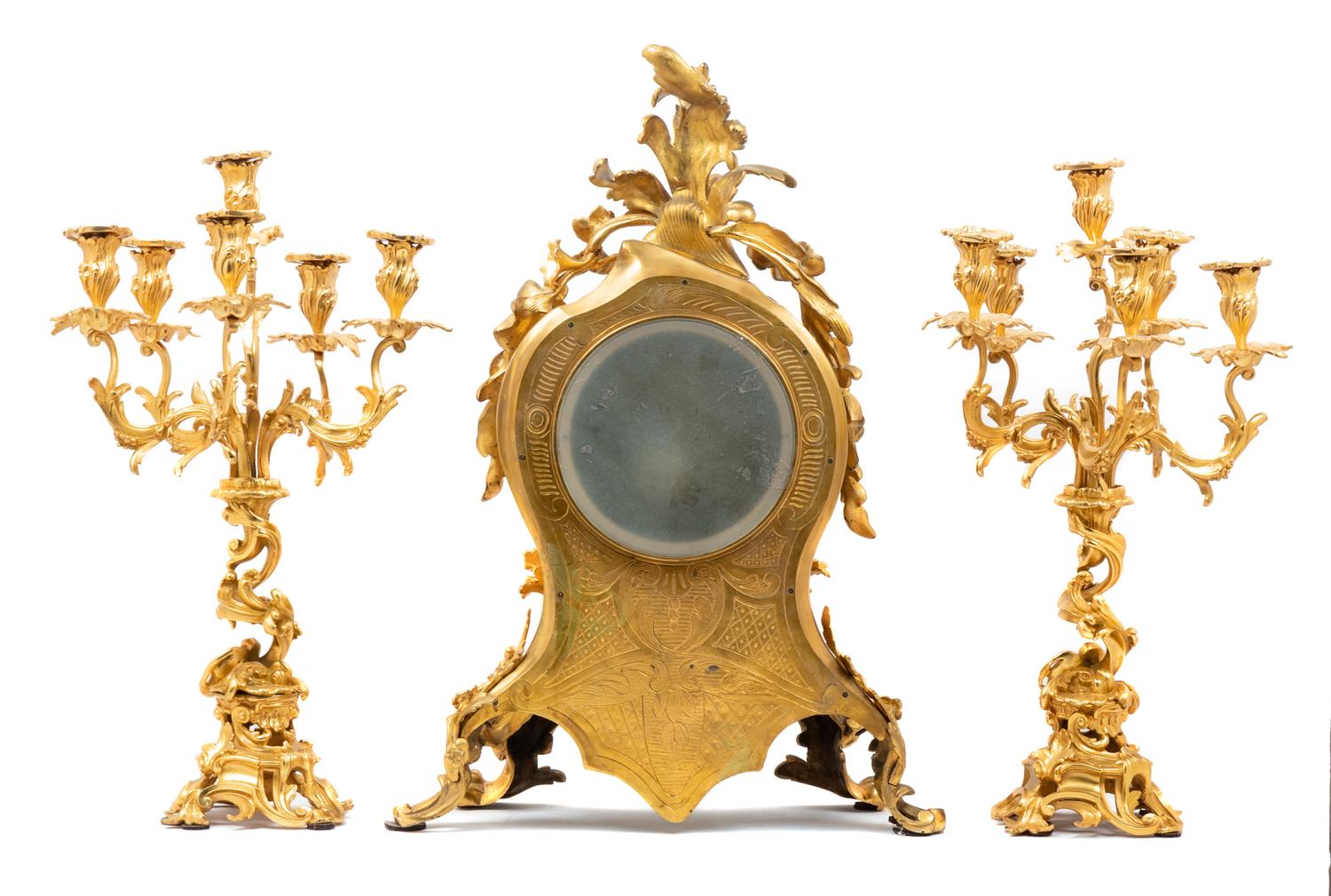 A Louis XV Style Gilt Bronze Three-Piece Clock Garniture