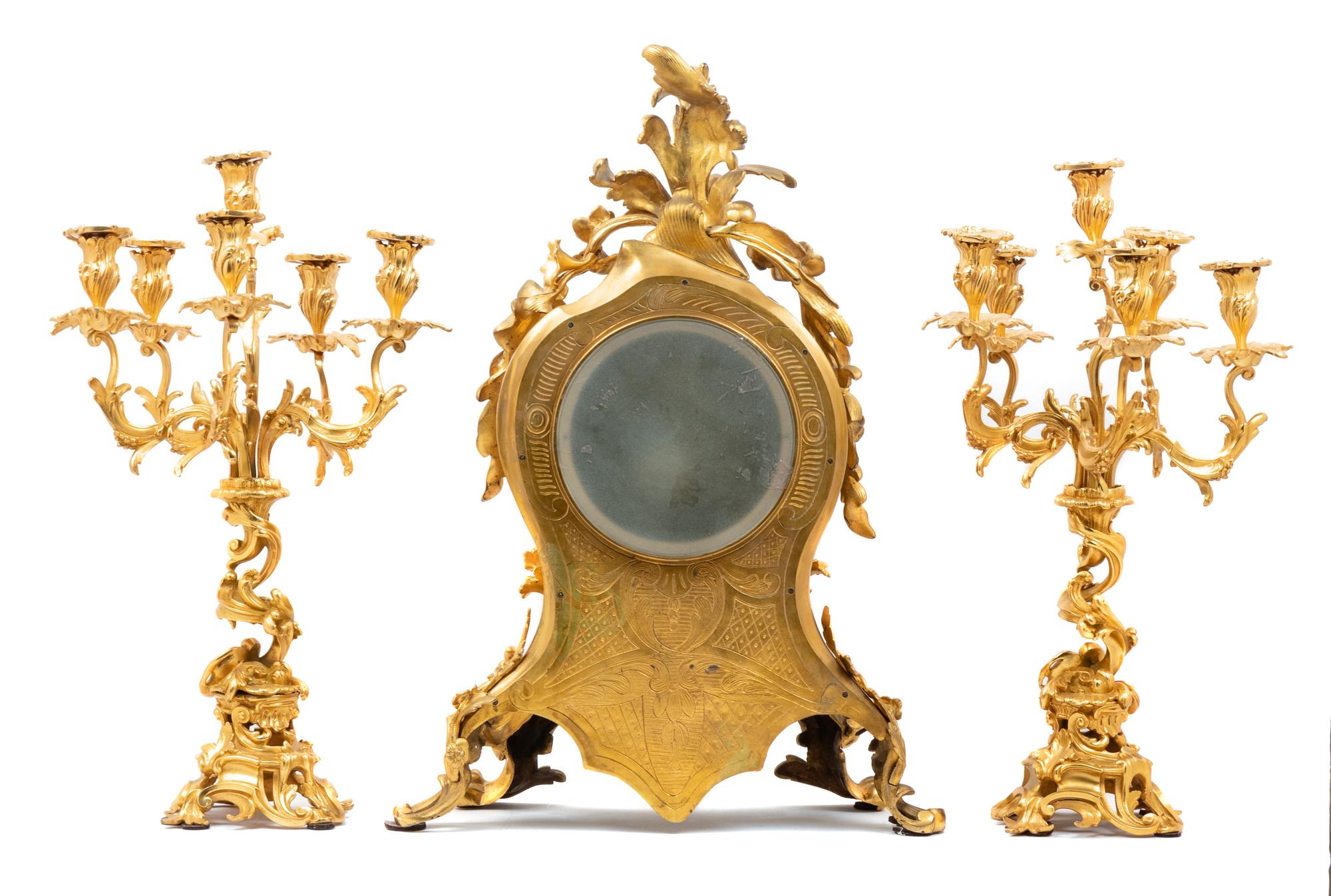 A Louis XV Style Gilt Bronze Three-Piece Clock Garniture