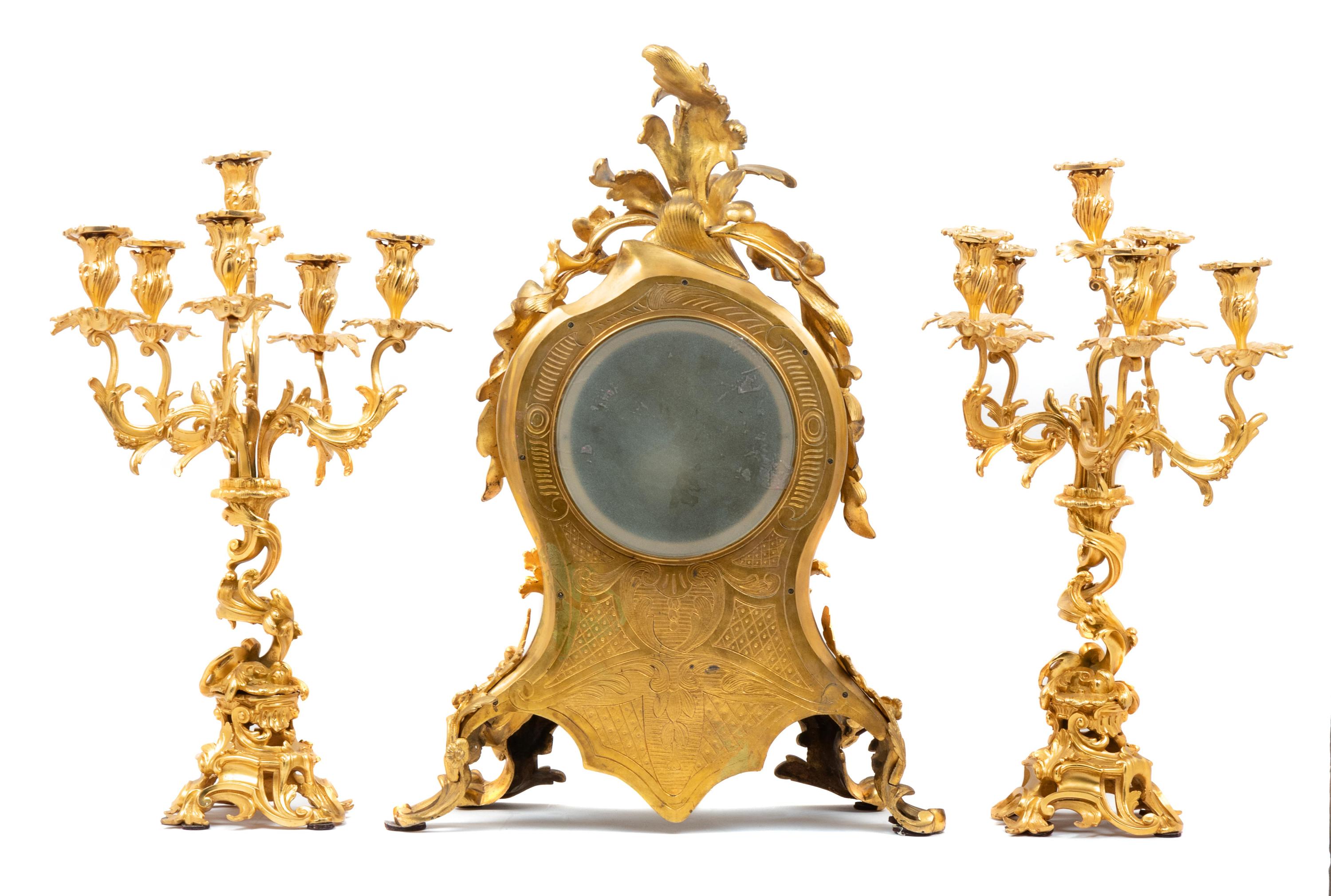 A Louis XV Style Gilt Bronze Three-Piece Clock Garniture