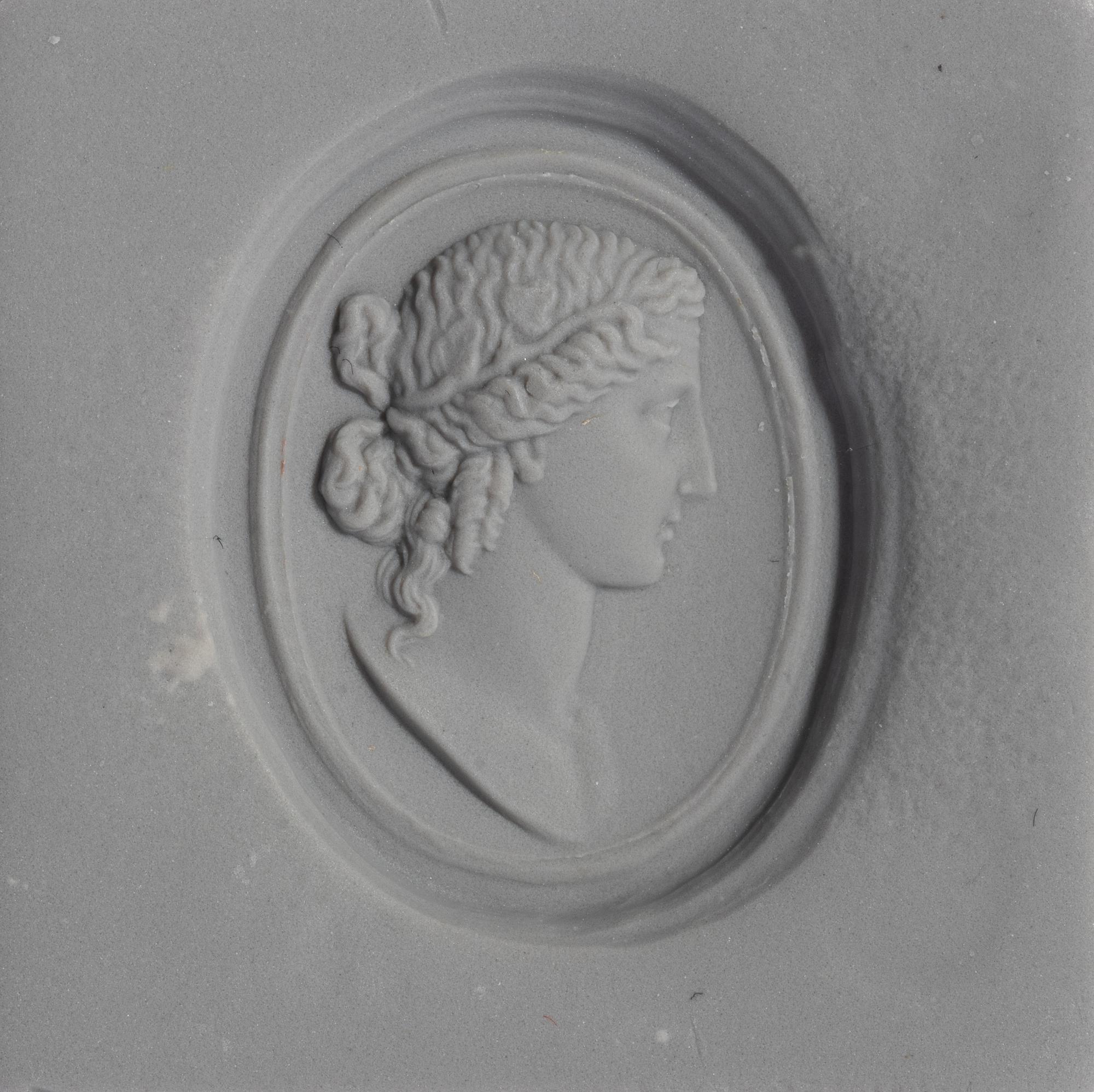 A Neoclassical Carnelian and Brass Finger Ring with a Bust of a Deity
