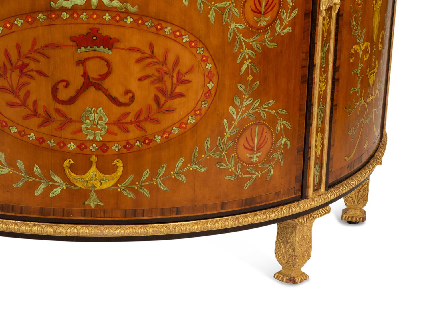 A Pair of Adam Style Painted Parcel Gilt and Marquetry Inlaid Demilune Commodes