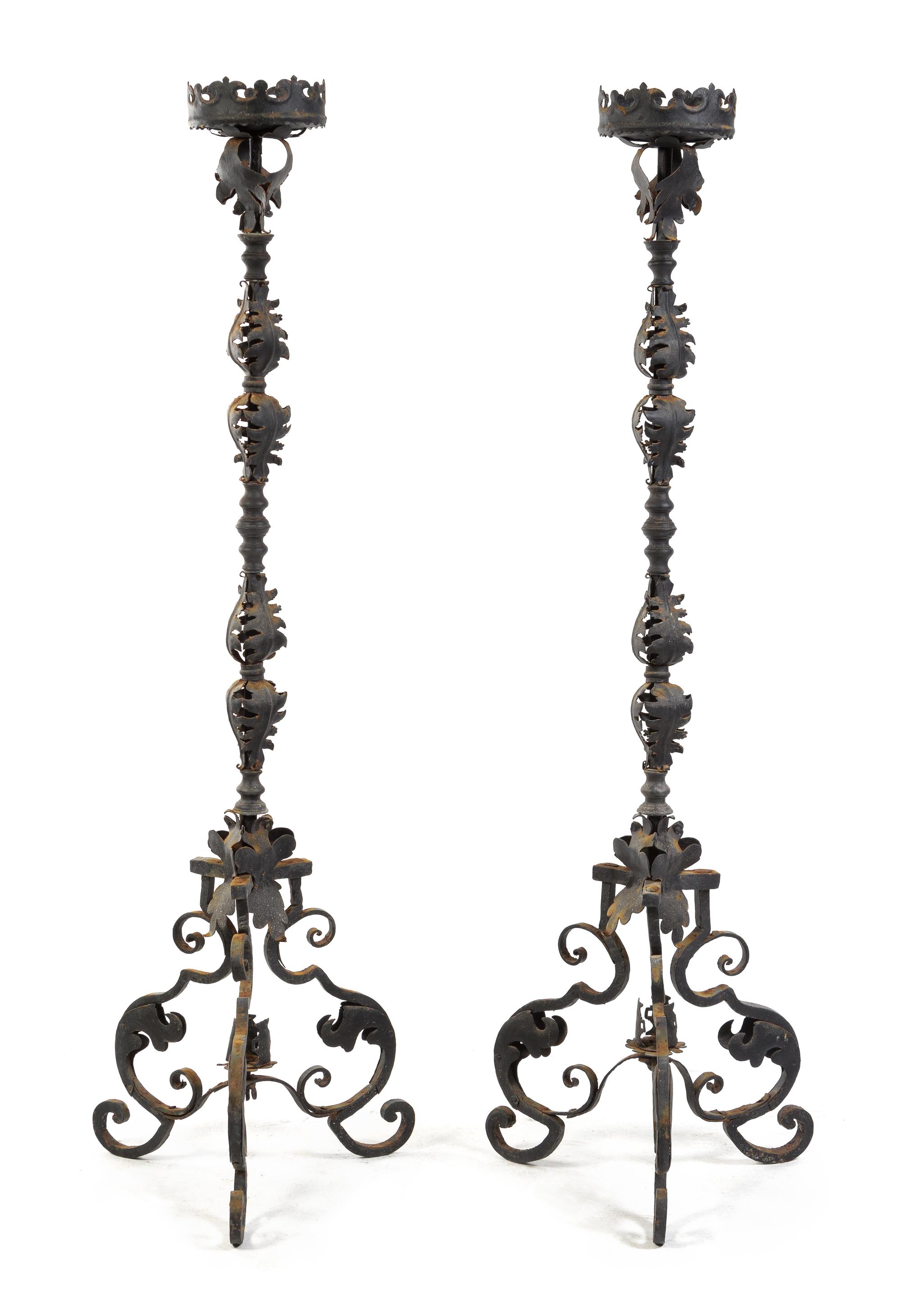 A Pair of Wrought Iron Prickets Height 67 inches.