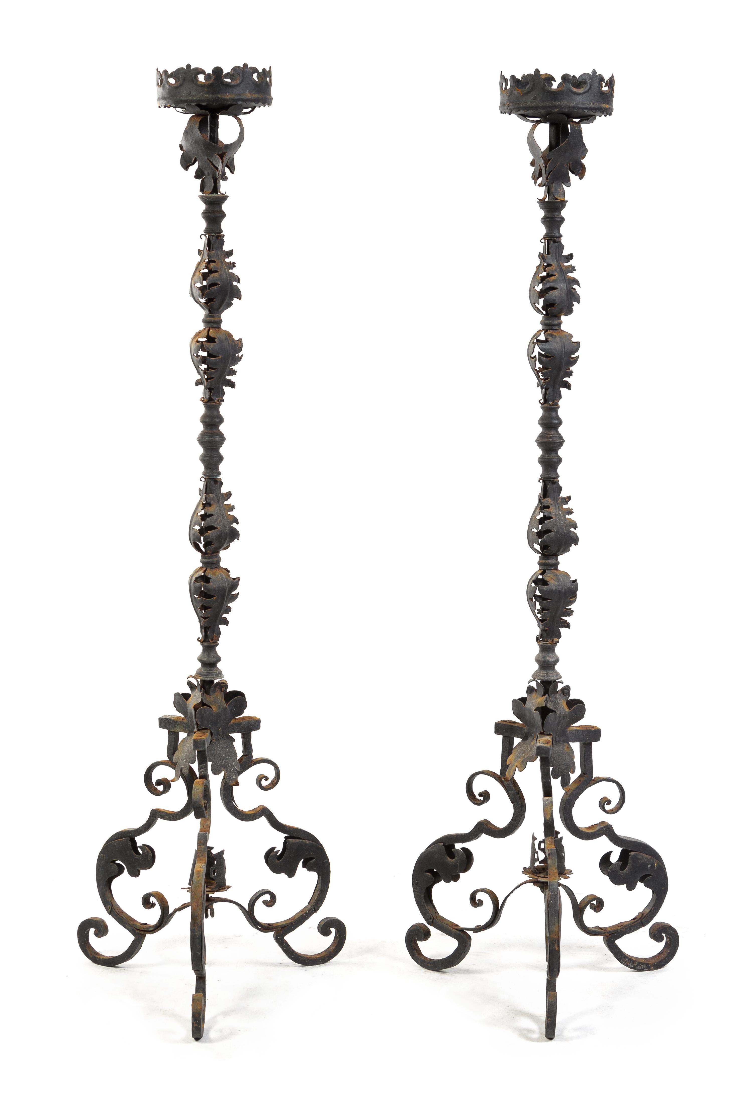 A Pair of Wrought Iron Prickets Height 67 inches.