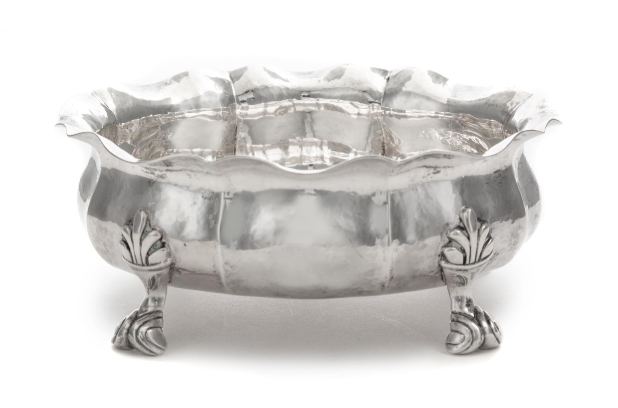 An Italian Silver Bowl, Buccellati, 20th Century, having a flared rim and an undulating body and raised on four foliate scroll decorate