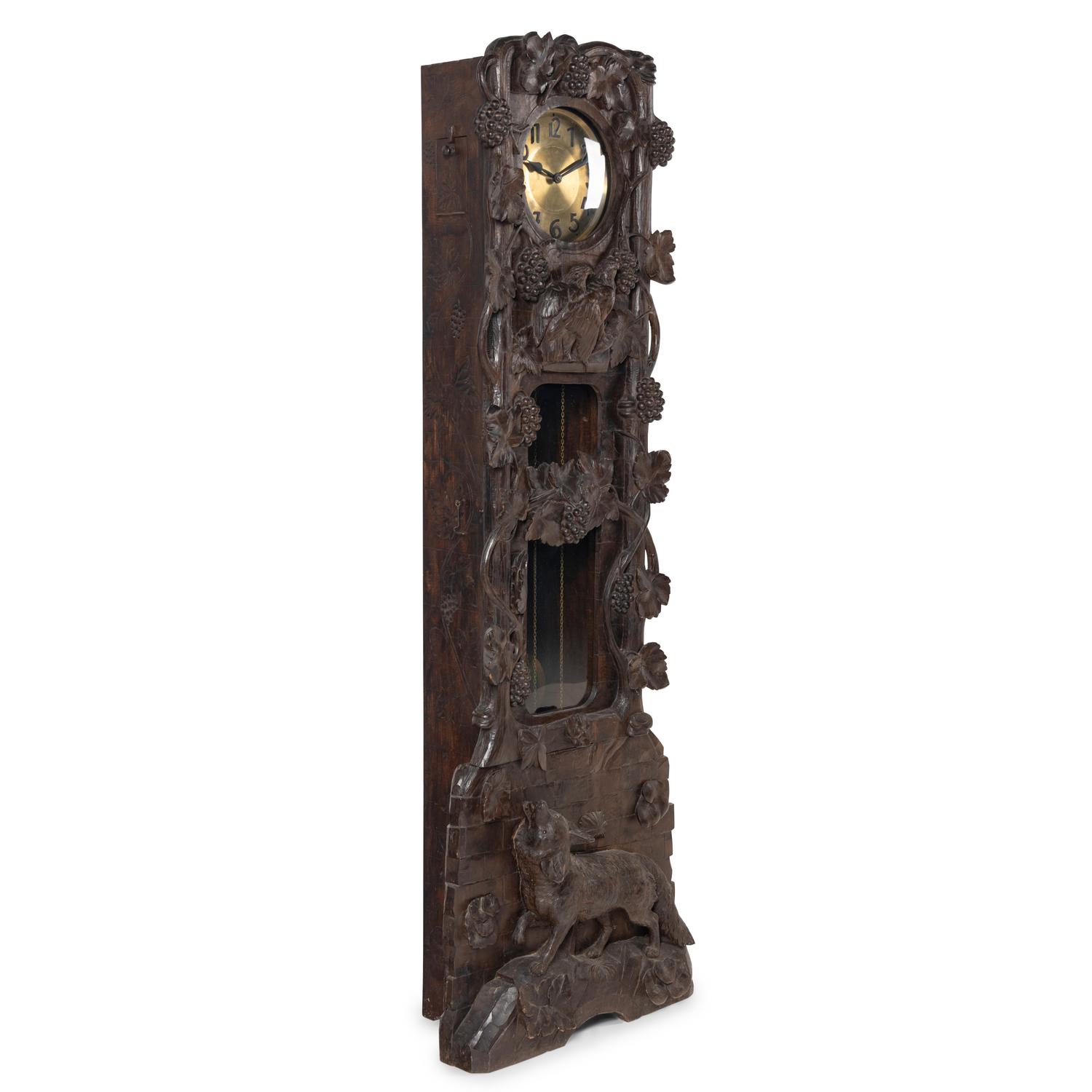 A Swiss Black Forest Carved Tall Case Clock