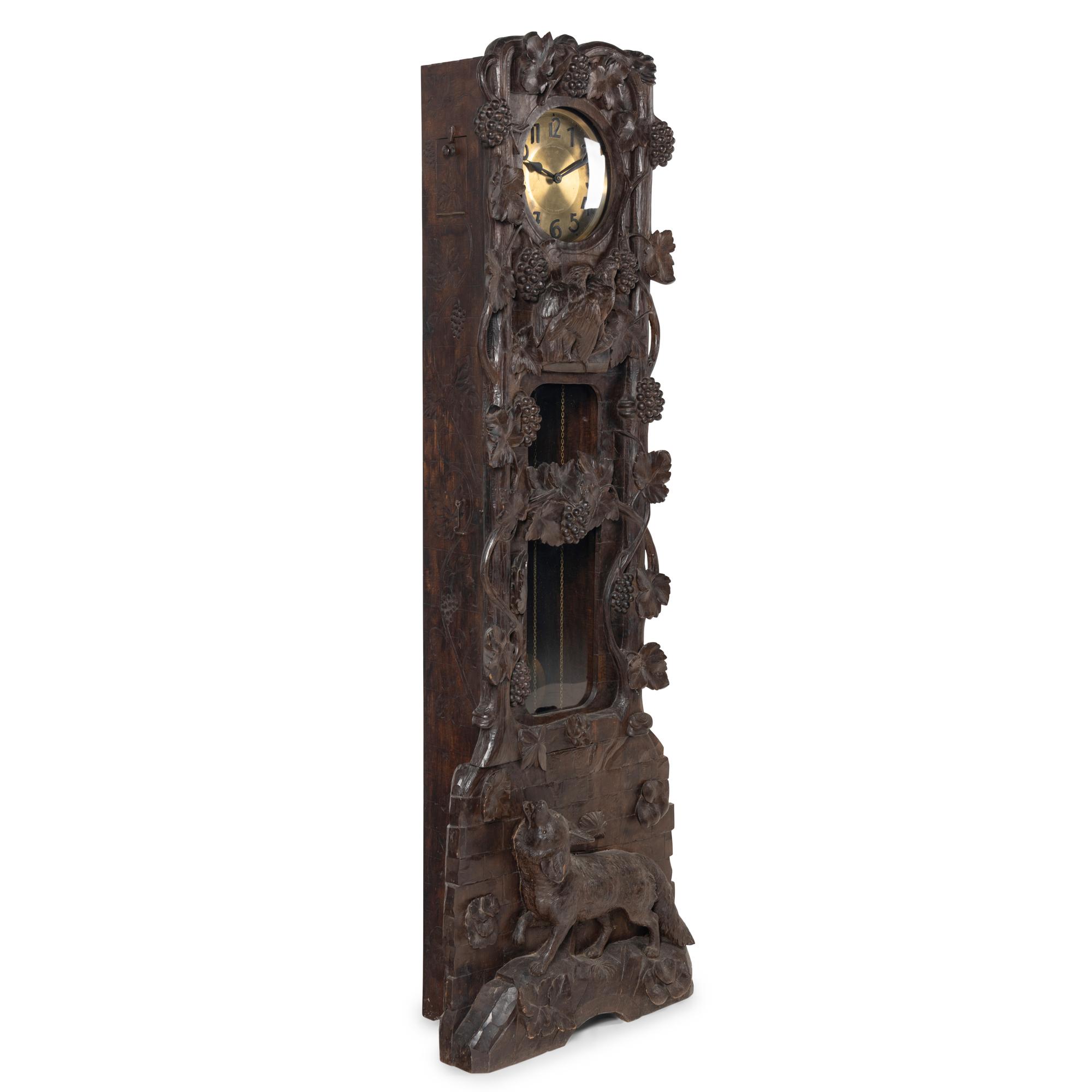A Swiss Black Forest Carved Tall Case Clock
