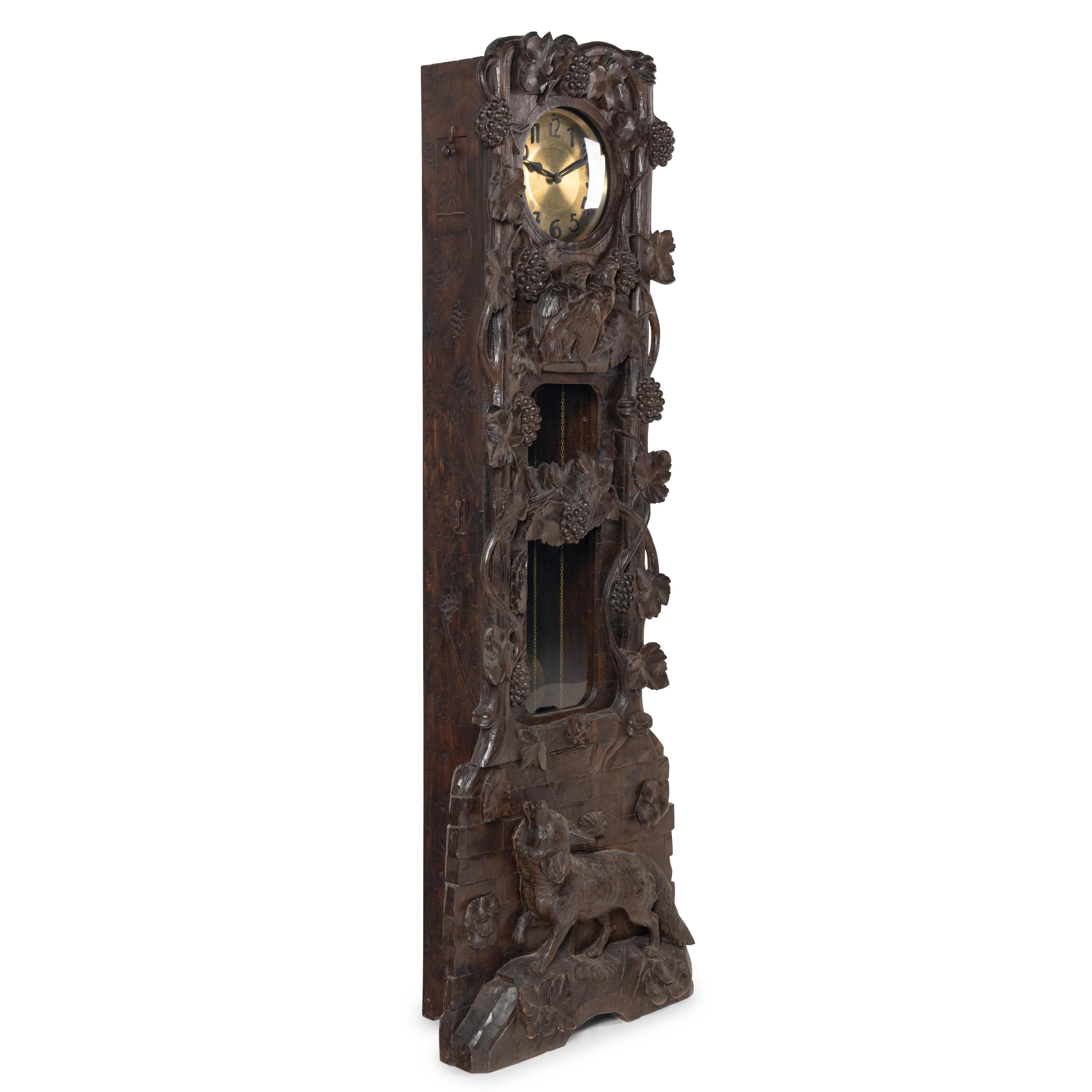 A Swiss Black Forest Carved Tall Case Clock