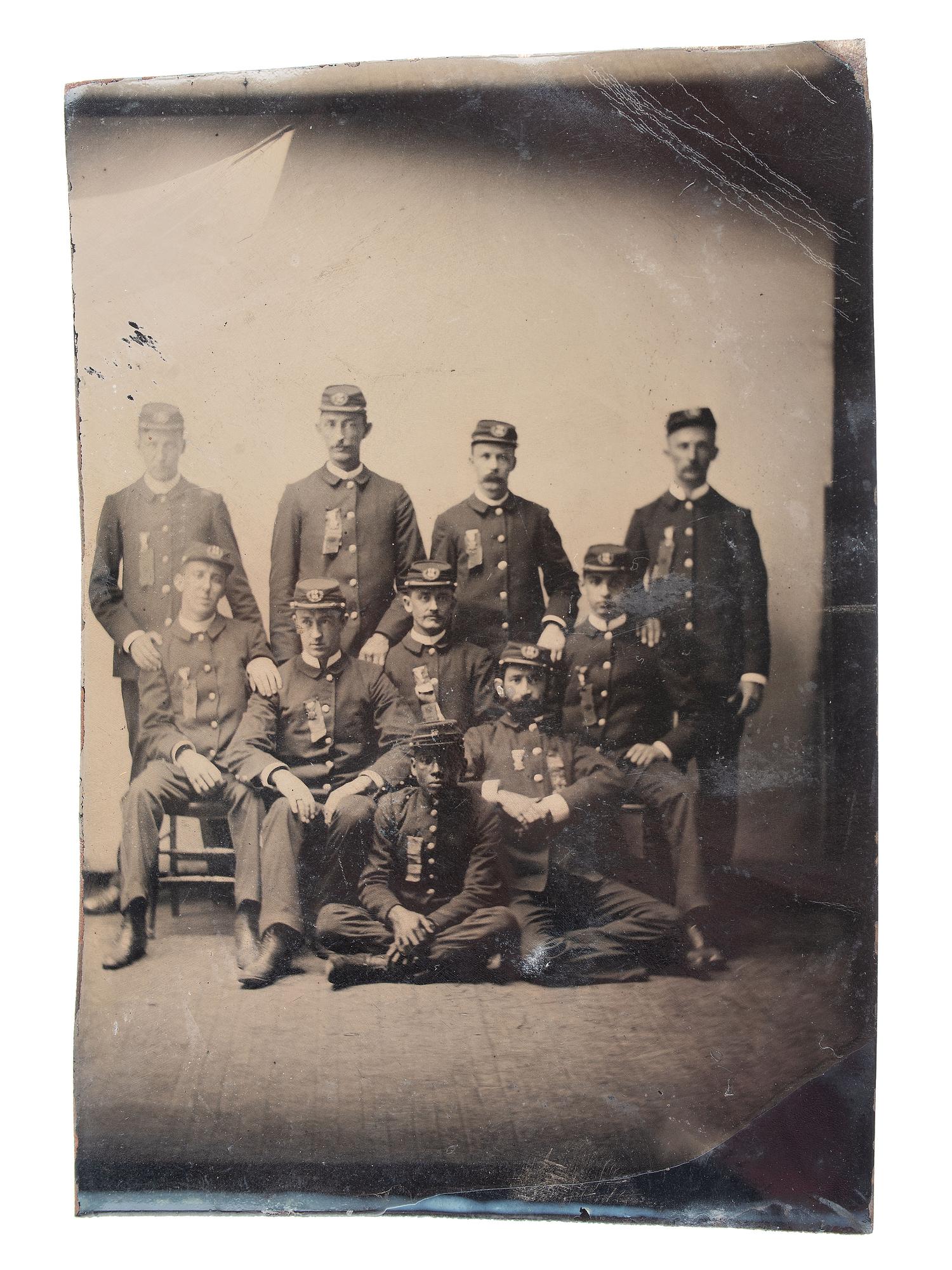 [AFRICAN AMERICANA - EARLY PHOTOGRAPHY]. CDV-sized tintype of a group of men in uniform, incl. African American subject.