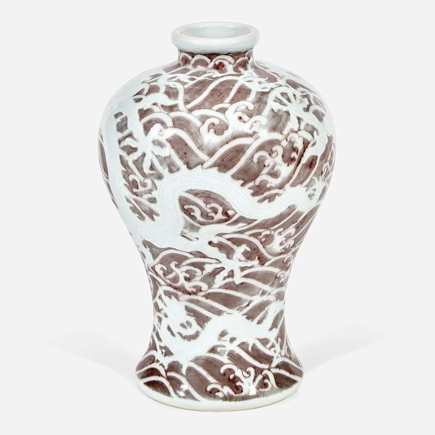 A Chinese carved and underglaze red "Dragons and Waves" vase, Meiping Yongzheng six-character mark and of the period