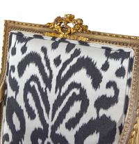 A Pair of Louis XVI Style Brunschwig & Fils Upholstered Cream-Painted and Parcel Gilt Fauteuils