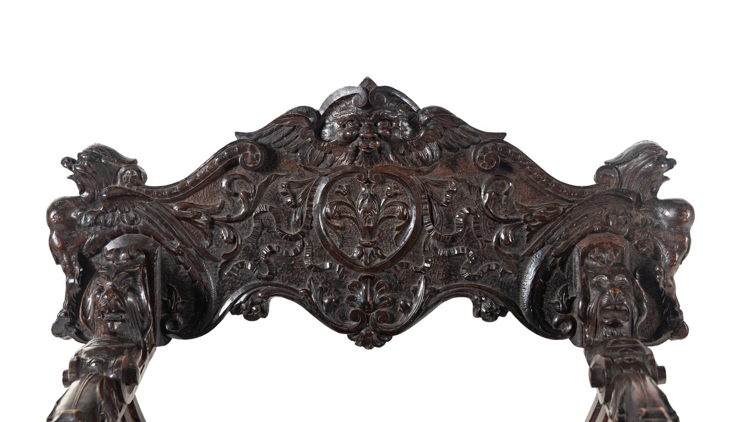 An Italian Renaissance Revival Carved Walnut Savonarola Armchair
