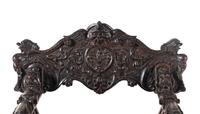 An Italian Renaissance Revival Carved Walnut Savonarola Armchair