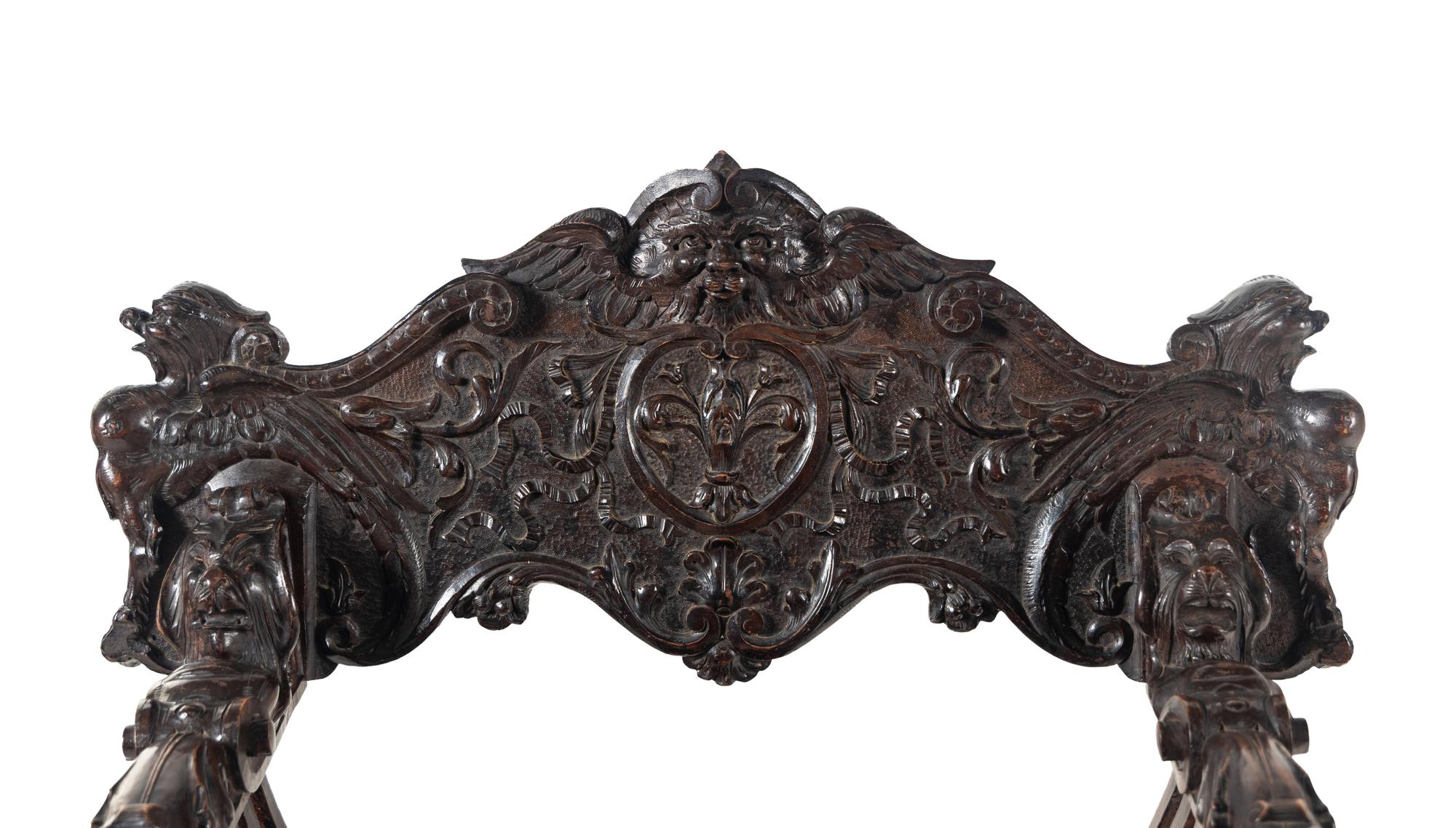 An Italian Renaissance Revival Carved Walnut Savonarola Armchair