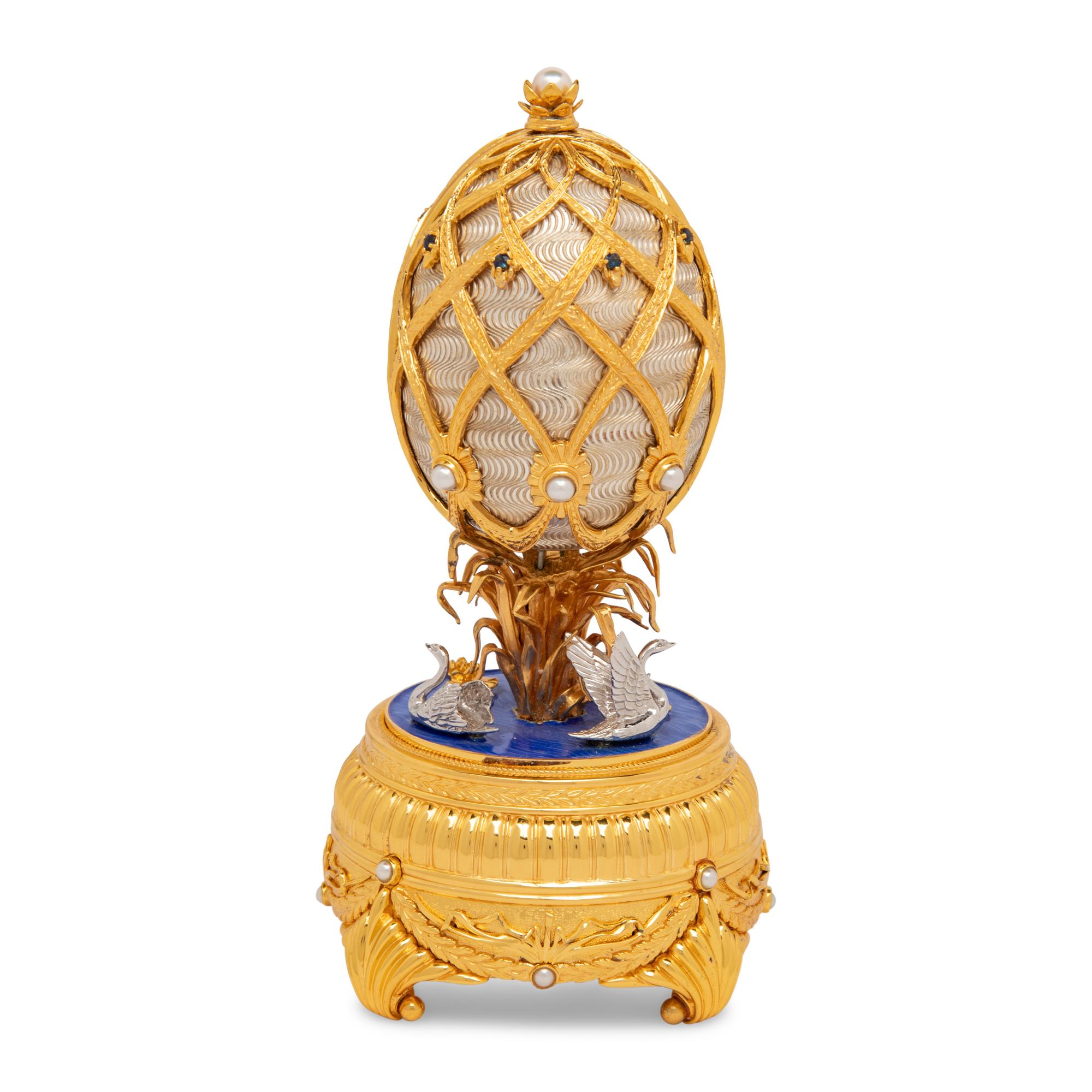 A Silver, Gilt and Enamel Decorated Swan Lake Egg-Form Music Box