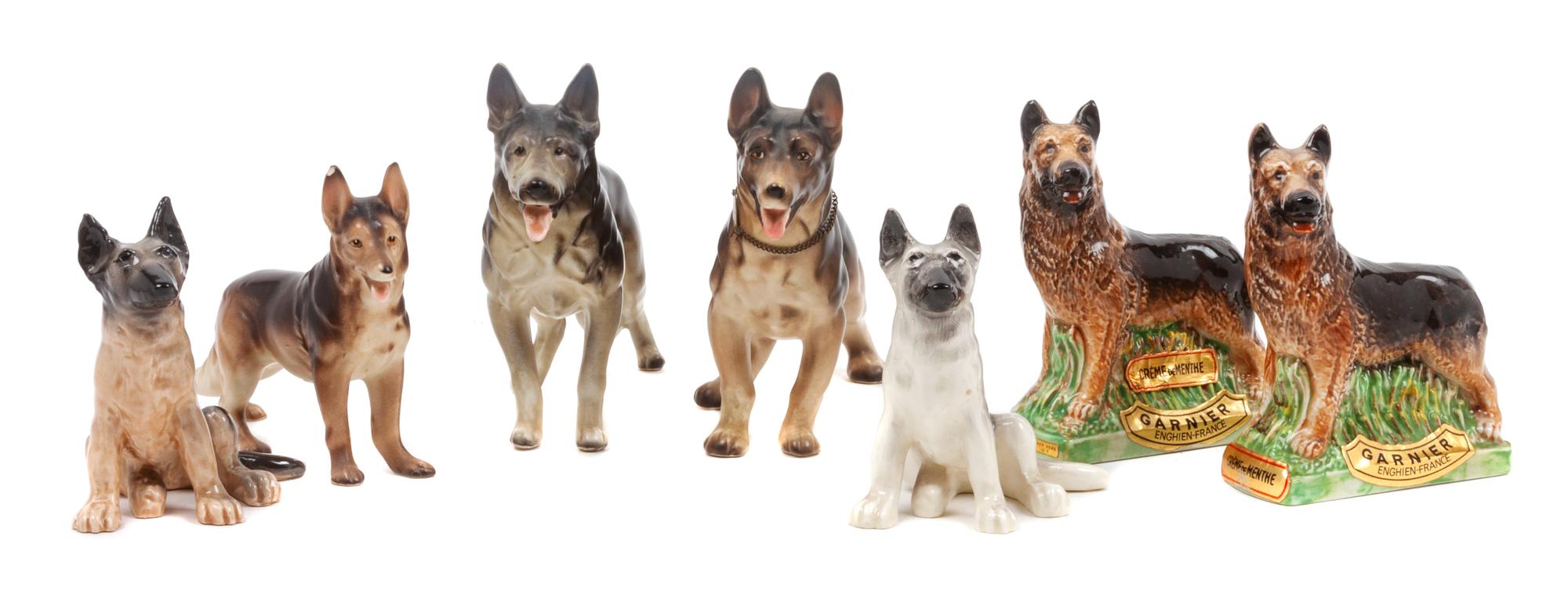 A Group of Eight Porcelain German Shepherds Width of widest 9 1/4 inches.