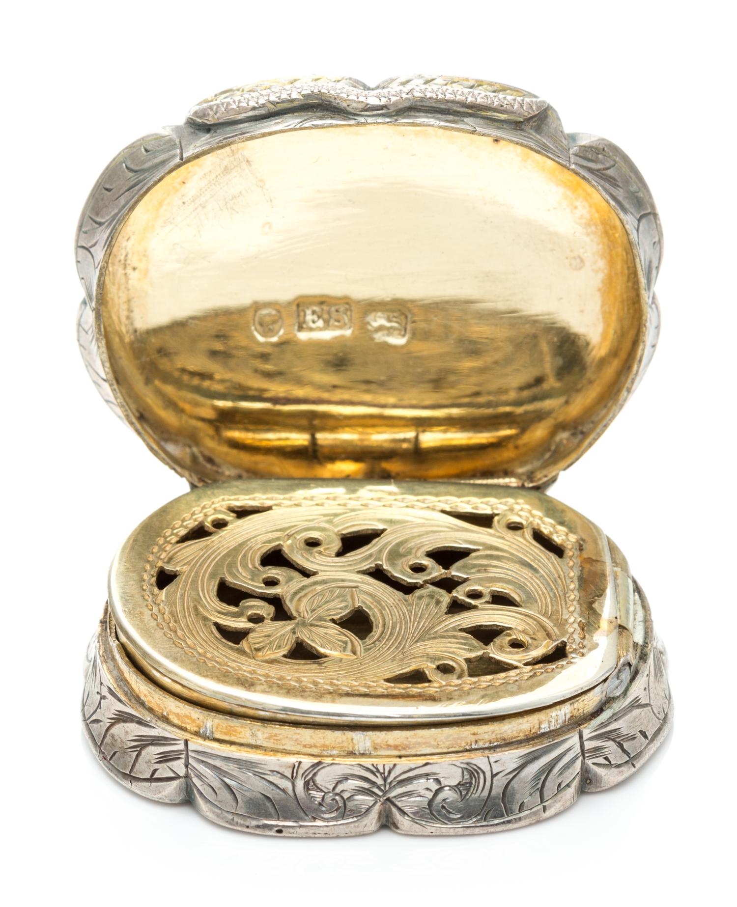 A Victorian Silver Vinaigrette, Edward Smith, Birmingham, 1857, of oval form with a scalloped rim, the sides worked with floral decorat