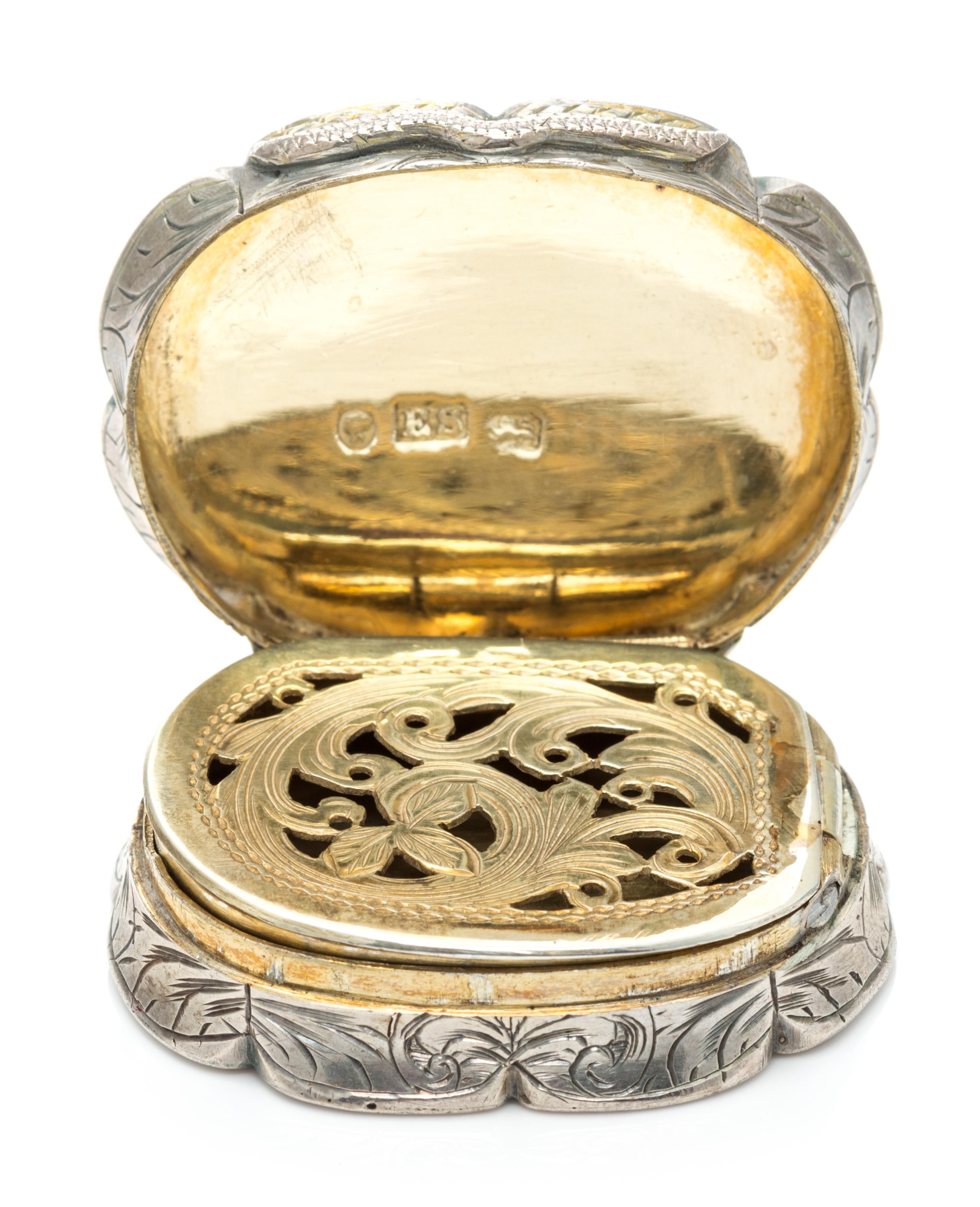 A Victorian Silver Vinaigrette, Edward Smith, Birmingham, 1857, of oval form with a scalloped rim, the sides worked with floral decorat
