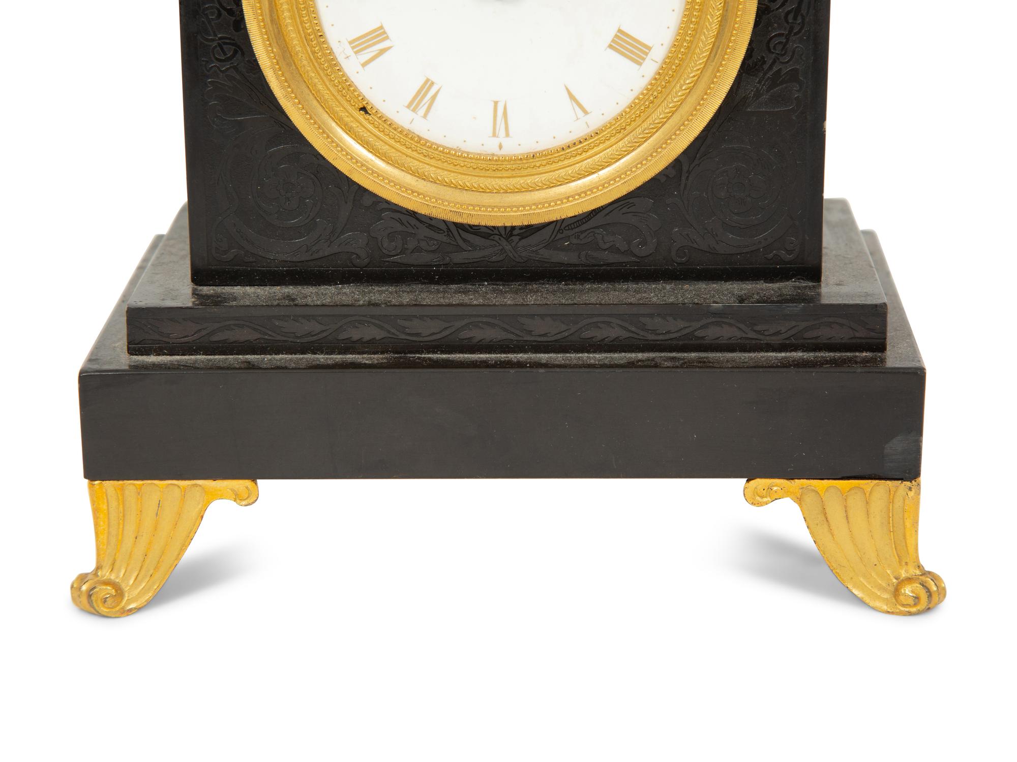 A Regency Black Slate and Gilt Bronze Mantel Clock