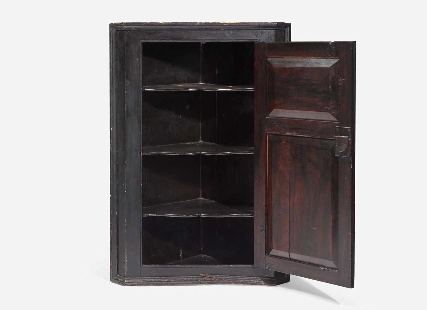 A Chippendale black-painted pine hanging corner cupboard, late 18th century