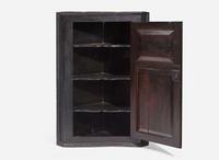 A Chippendale black-painted pine hanging corner cupboard, late 18th century