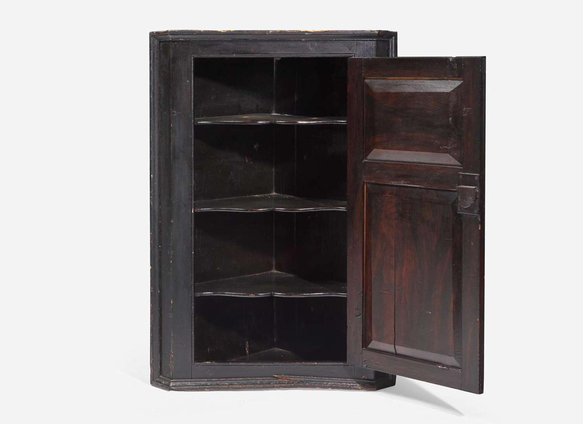 A Chippendale black-painted pine hanging corner cupboard, late 18th century
