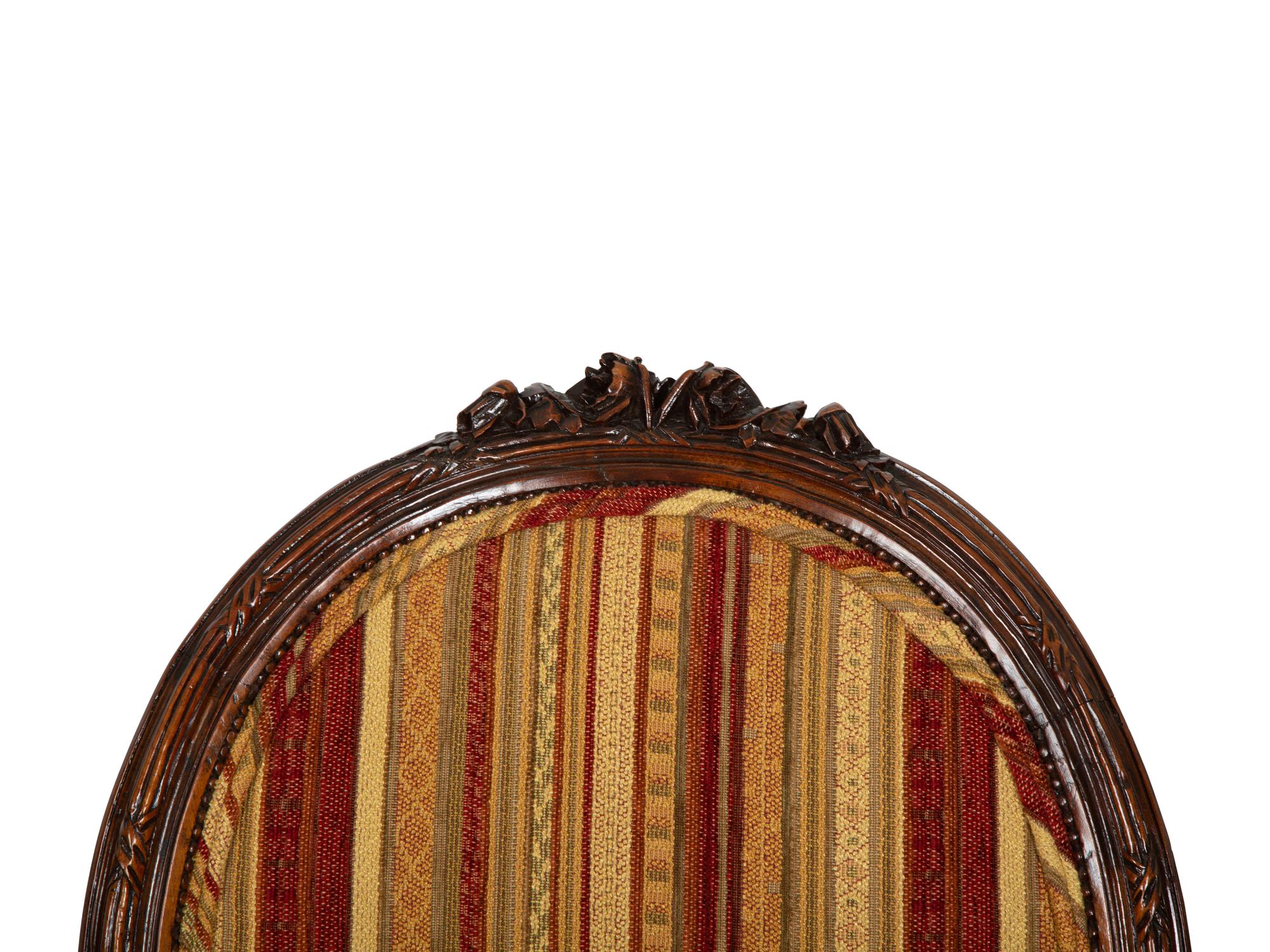 Four Louis XVI Style Carved Walnut Chairs
