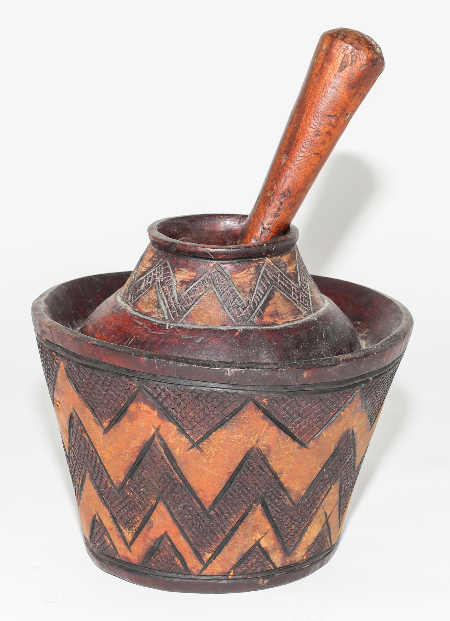 A Bobo Carved Wood Mortar & Pestle. Diameter 8 1/2 inches.
