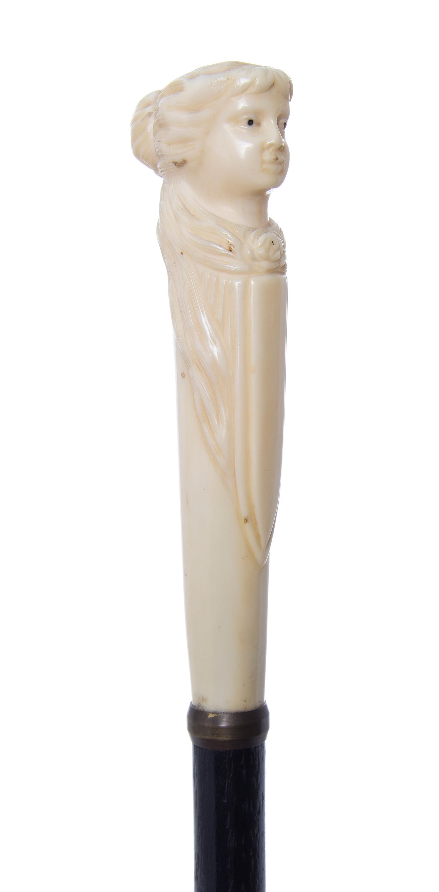 An American Walrus Ivory Handled Cane, Length of handle 5 1/2 x length overall 35 7/8 inches.