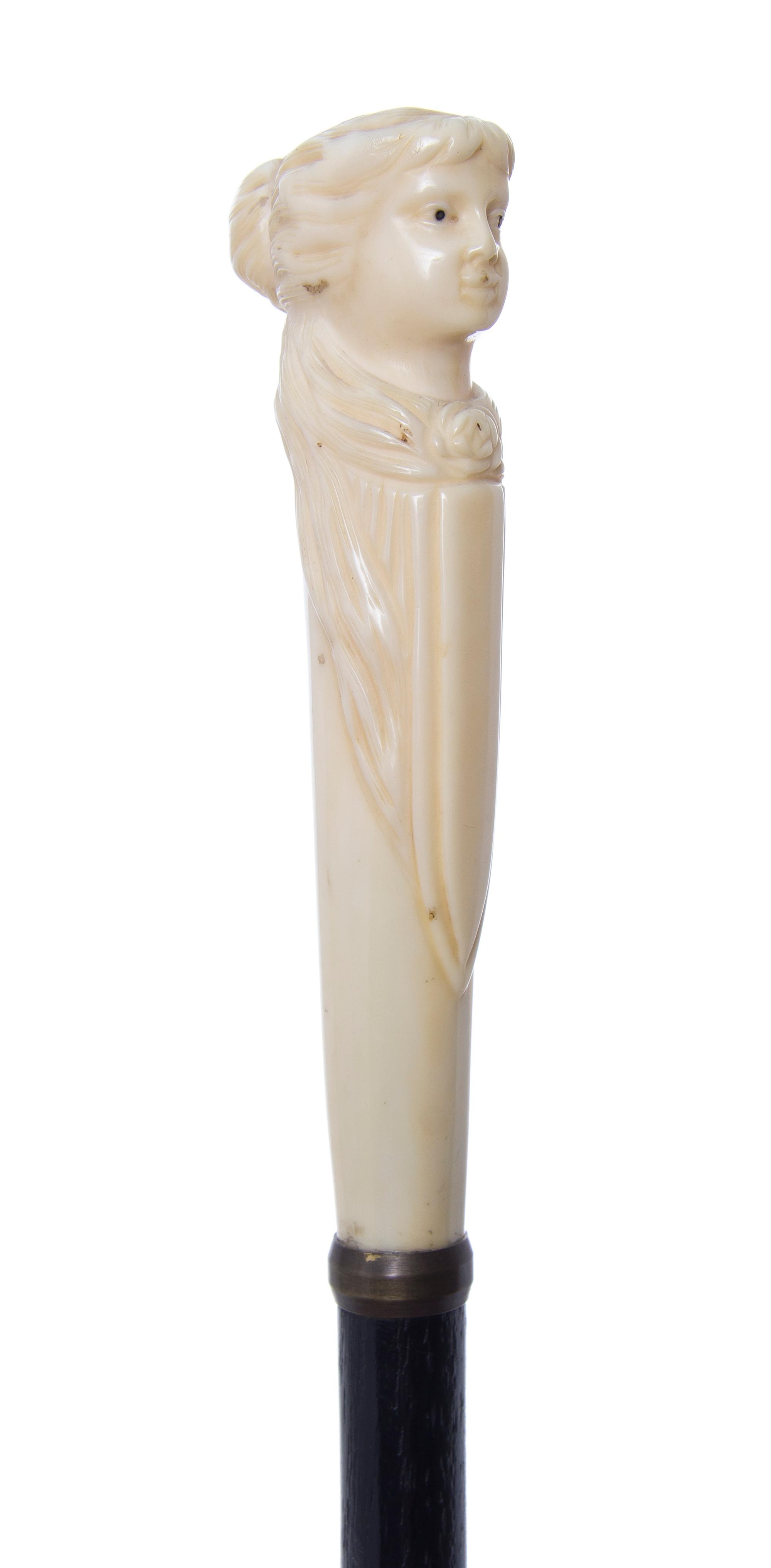 An American Walrus Ivory Handled Cane, Length of handle 5 1/2 x length overall 35 7/8 inches.
