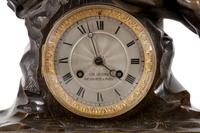 An Empire Style Gilt and Patinated Bronze and Marble Clock Garniture
