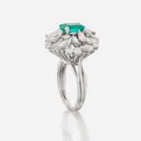 An emerald, diamond, and platinum ring