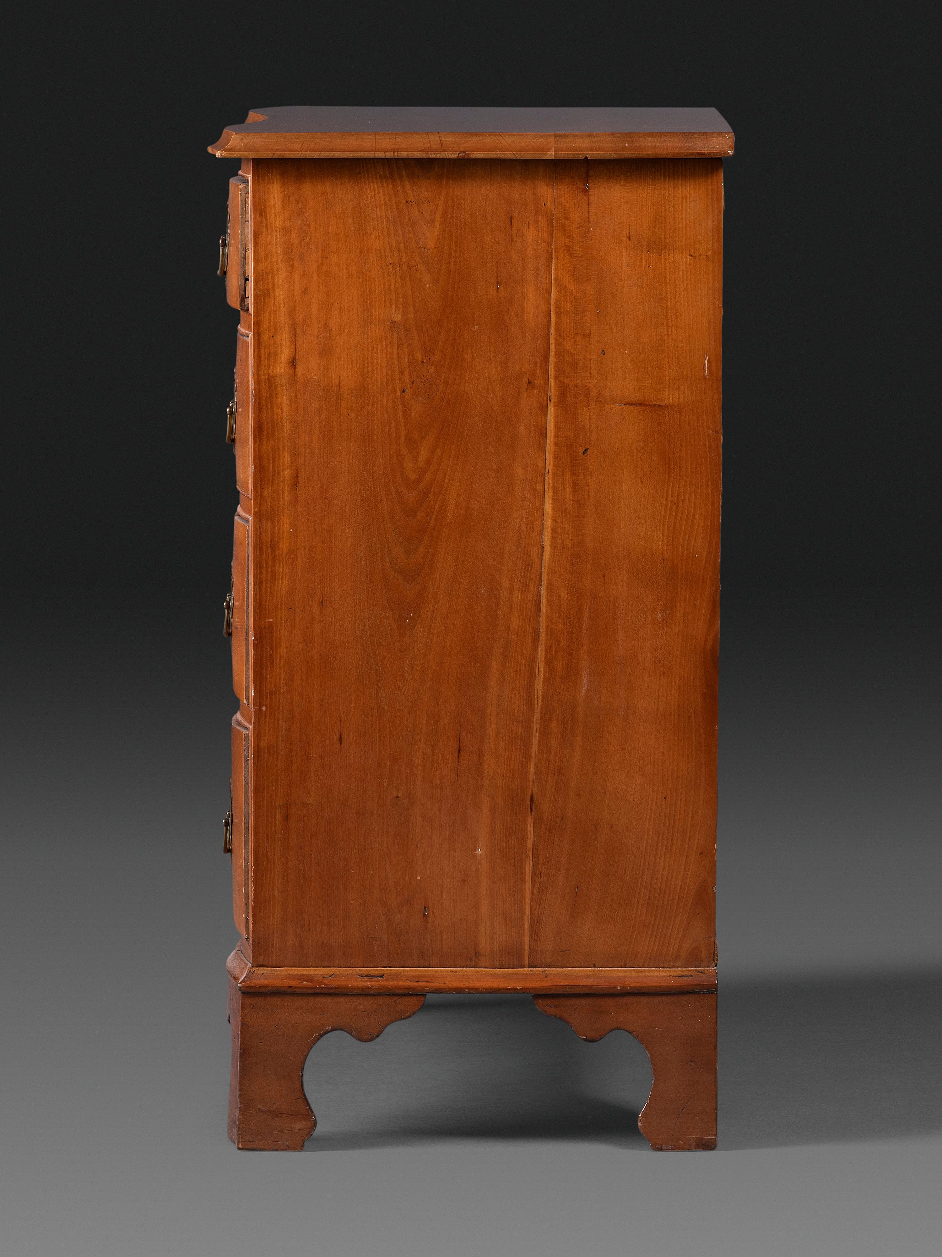A Chippendale Cherrywood Reverse-Serpentine Chest of Drawers