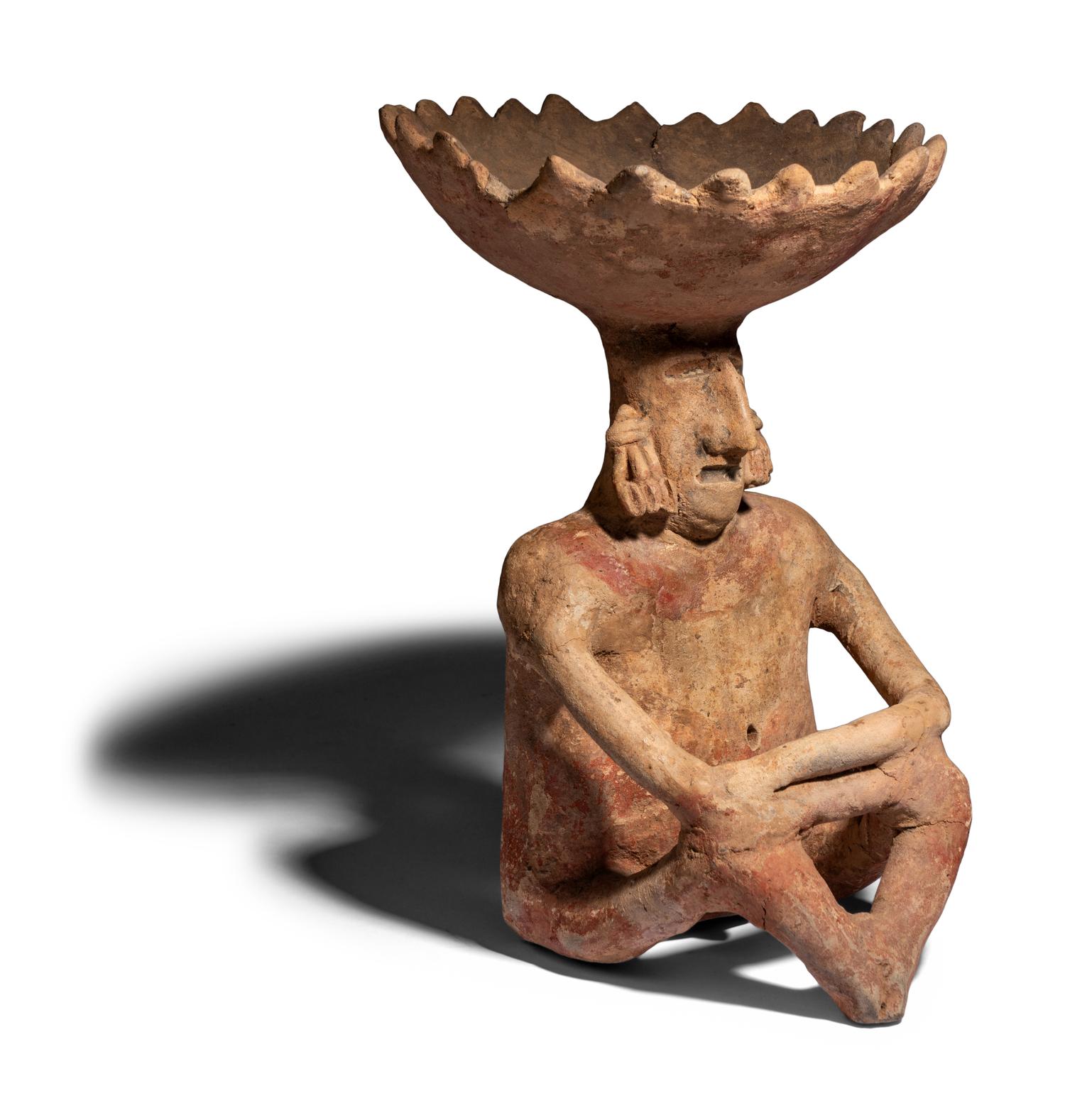 A Colima Terracotta Seated Figure with Bowl Head