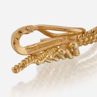 A pair of eighteen karat gold ear clips and a sterling silver and eighteen karat gold brooch, Tiffany & Co.